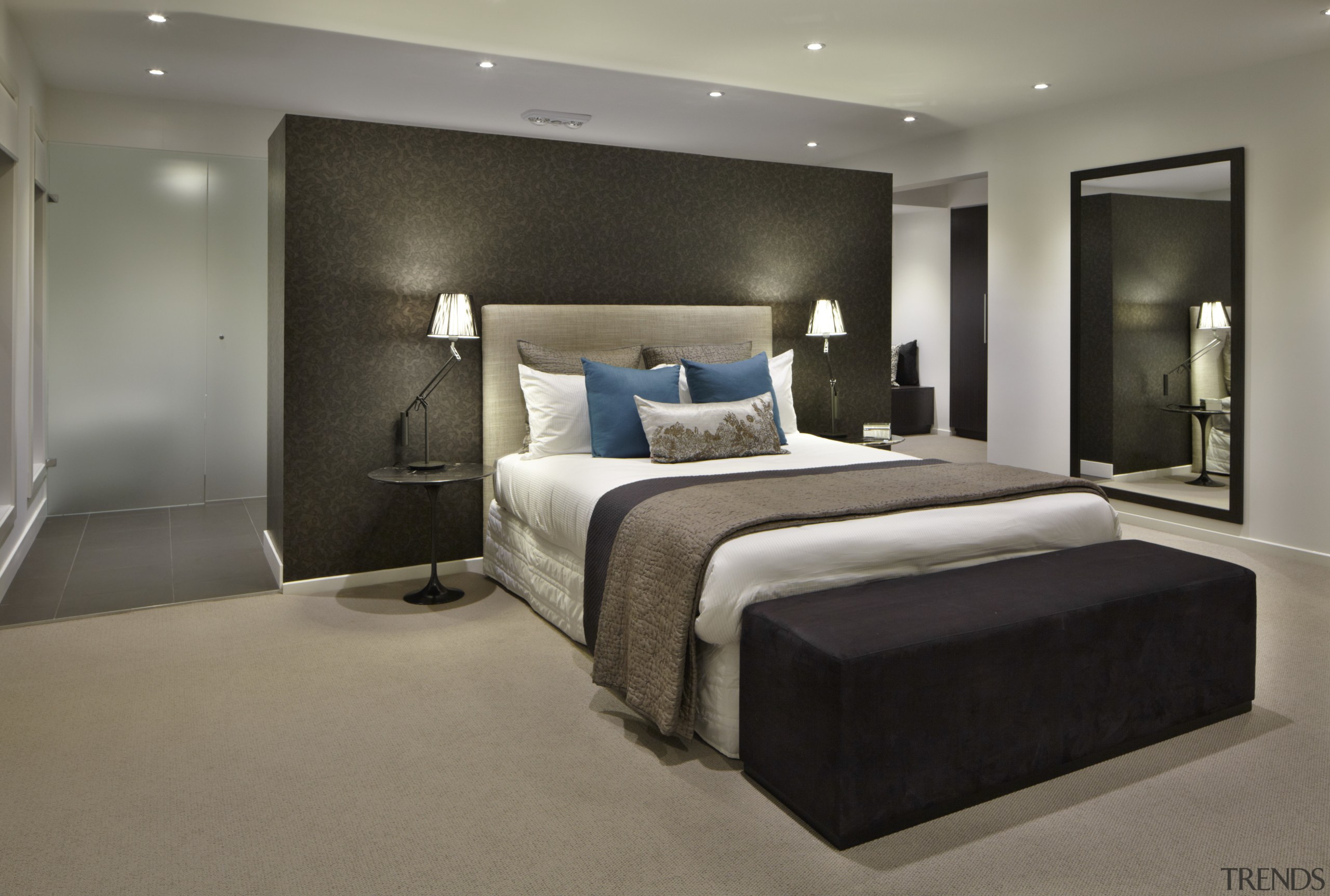 Bedroom with grey carpet and black storage container. bed frame, bedroom, ceiling, floor, interior design, room, suite, wall, gray, black