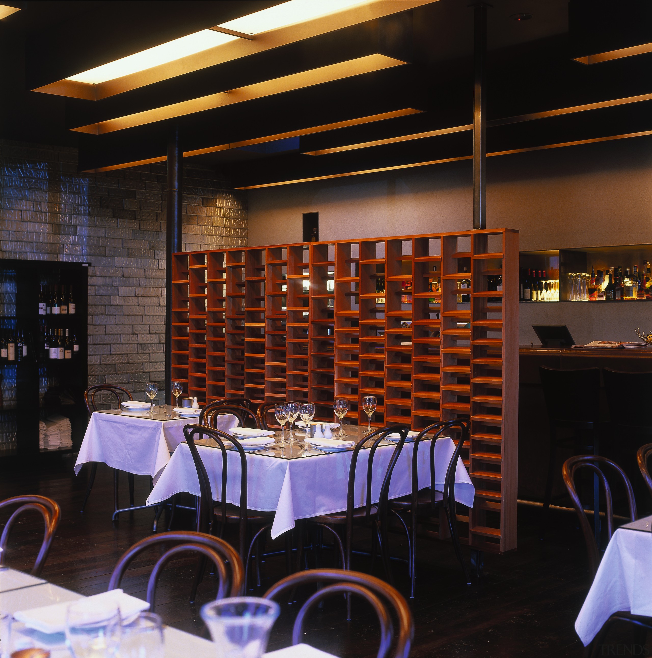 Small restaurant tables and chairs against feature screen. function hall, interior design, lighting, restaurant, table, black