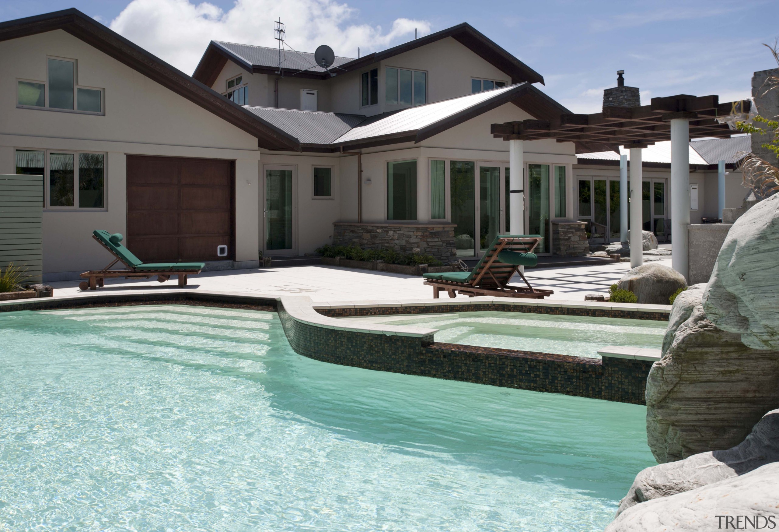 View of contemporary house with pool. - View backyard, estate, home, house, leisure, property, real estate, residential area, resort, swimming pool, villa, water, teal, black