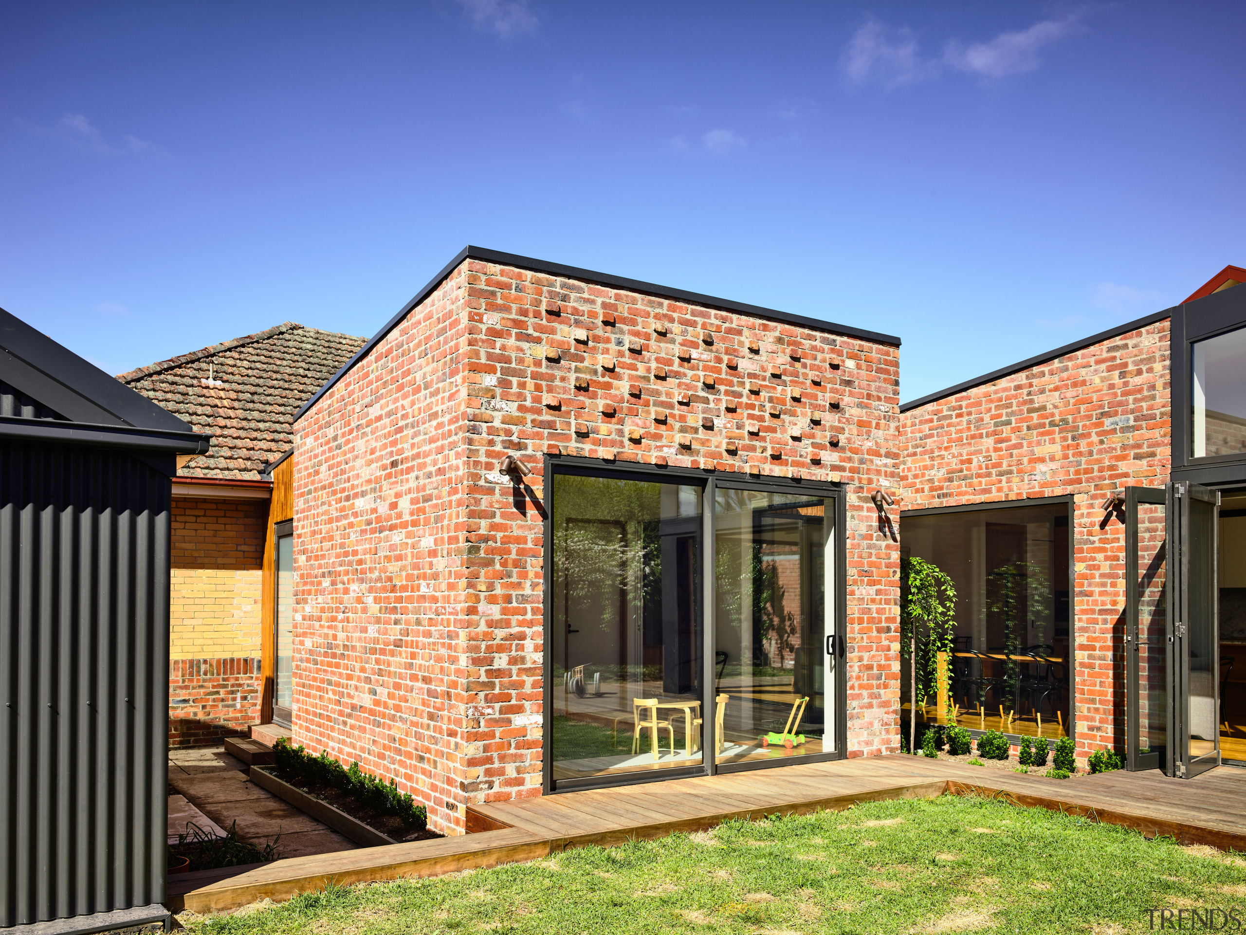 ​​​​​​​Looking like it is stand-alone, this new rumpus brick, facade, home, house, property, rresidential area, siding, bifold window, brick extension, Porter architecture