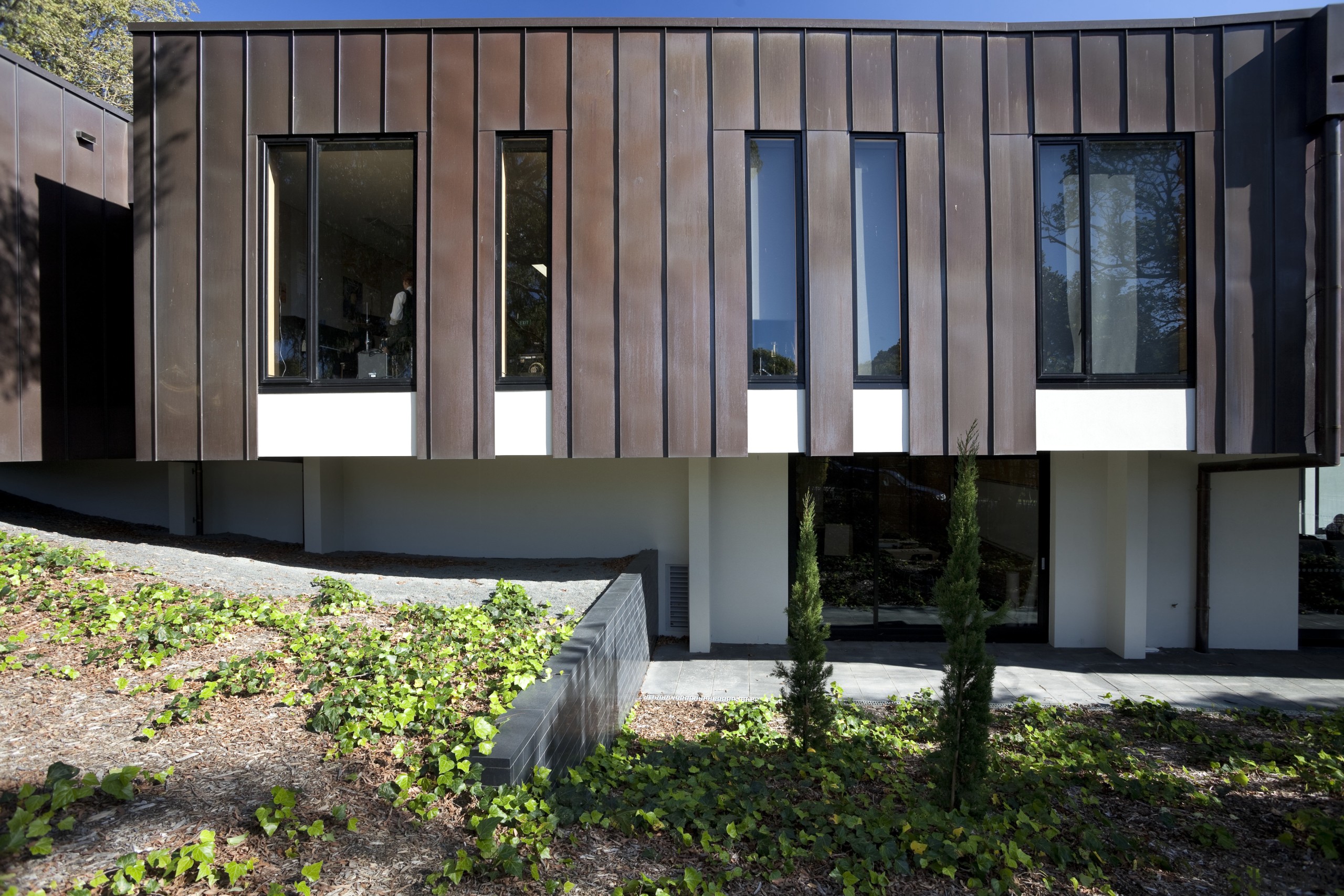 Exterior with dark red and white cladding and architecture, building, facade, home, house, real estate, window, black, gray