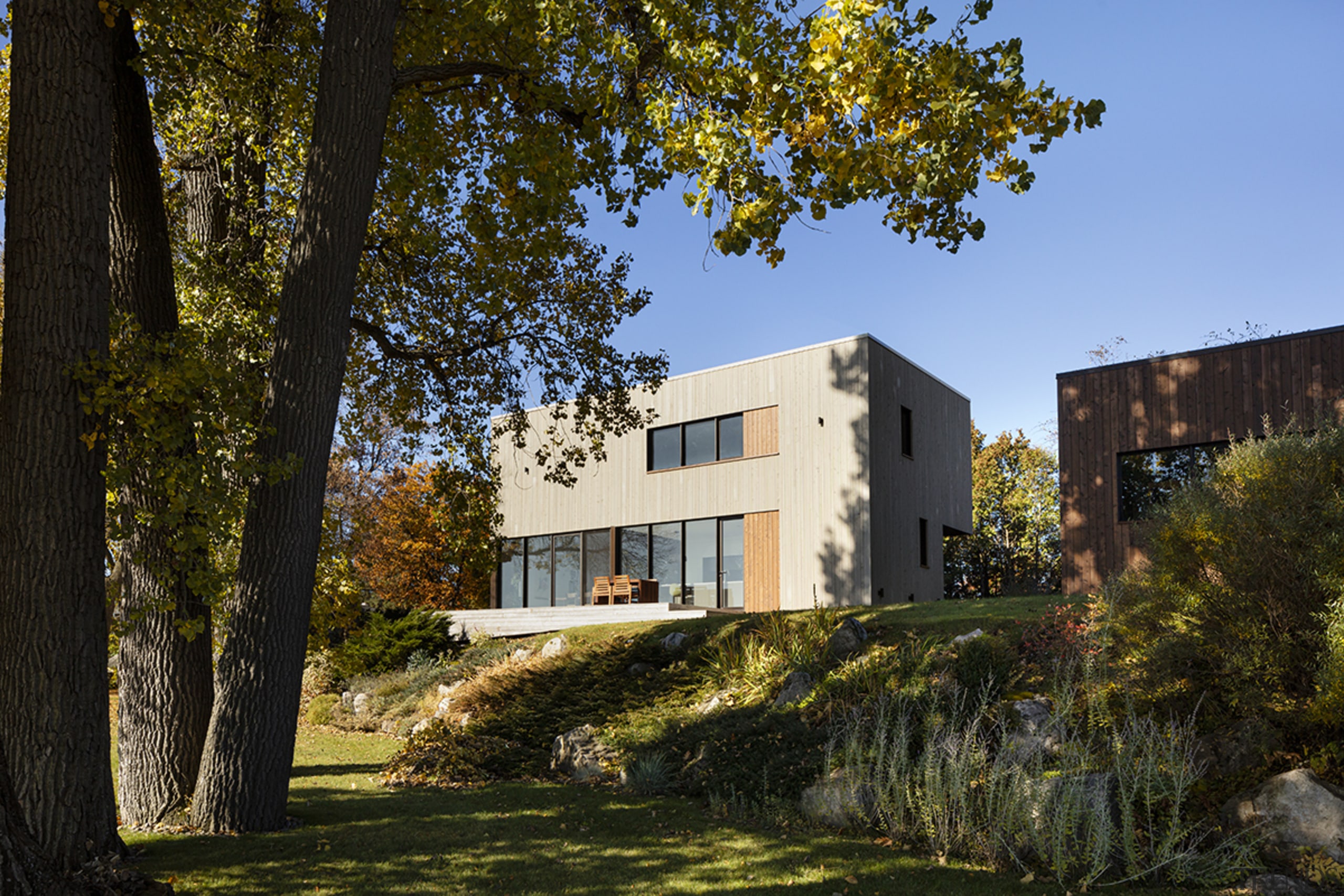 Positioned between road and river, the St-Ignace house black, brown