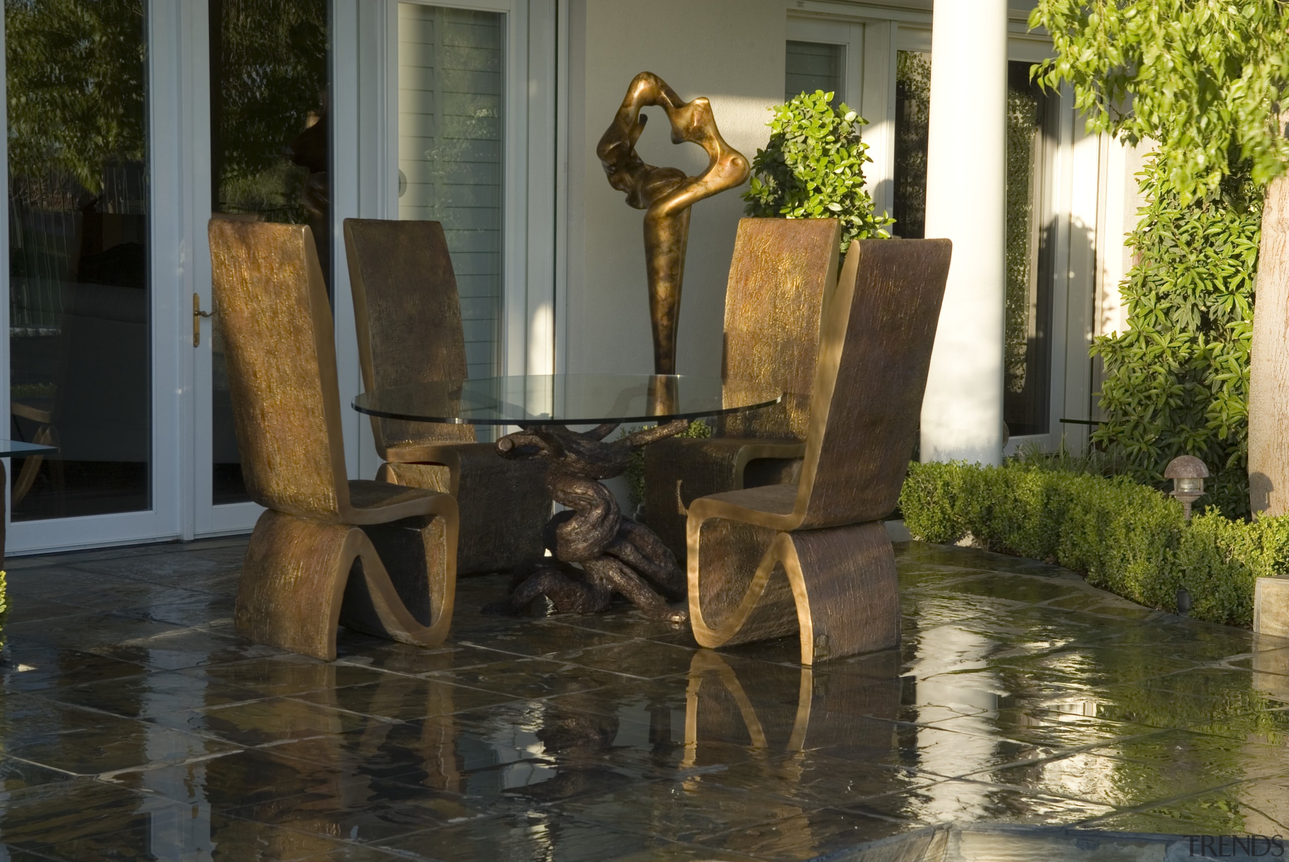 A view of the outdoor furniture and sculptures floor, flooring, furniture, interior design, outdoor structure, plant, reflection, sculpture, tourist attraction, tree, water, brown