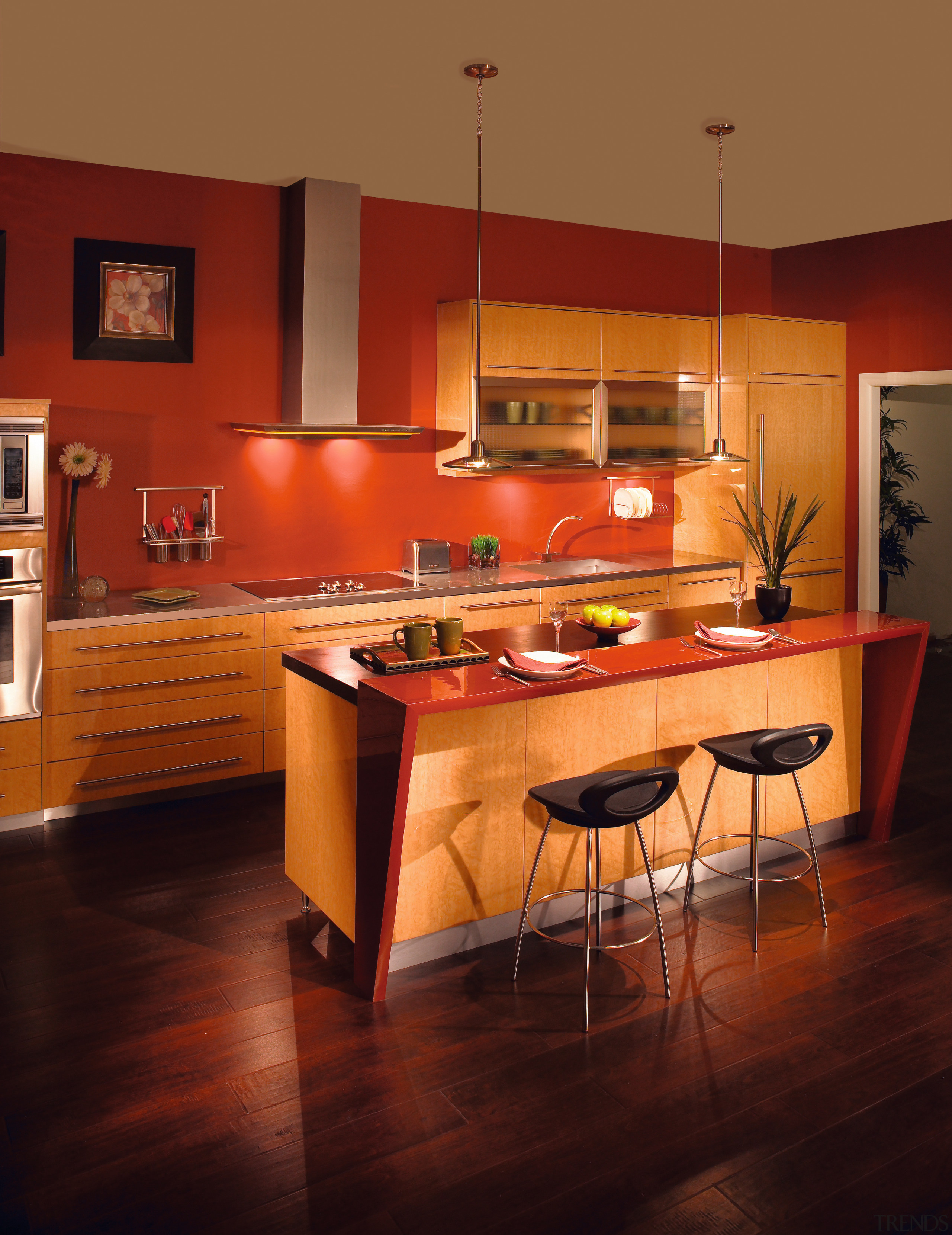 View of a custom kitchen which features cabinetry cabinetry, countertop, cuisine classique, dining room, floor, flooring, furniture, hardwood, home, interior design, kitchen, light fixture, lighting, room, table, under cabinet lighting, wood, wood flooring, red, brown