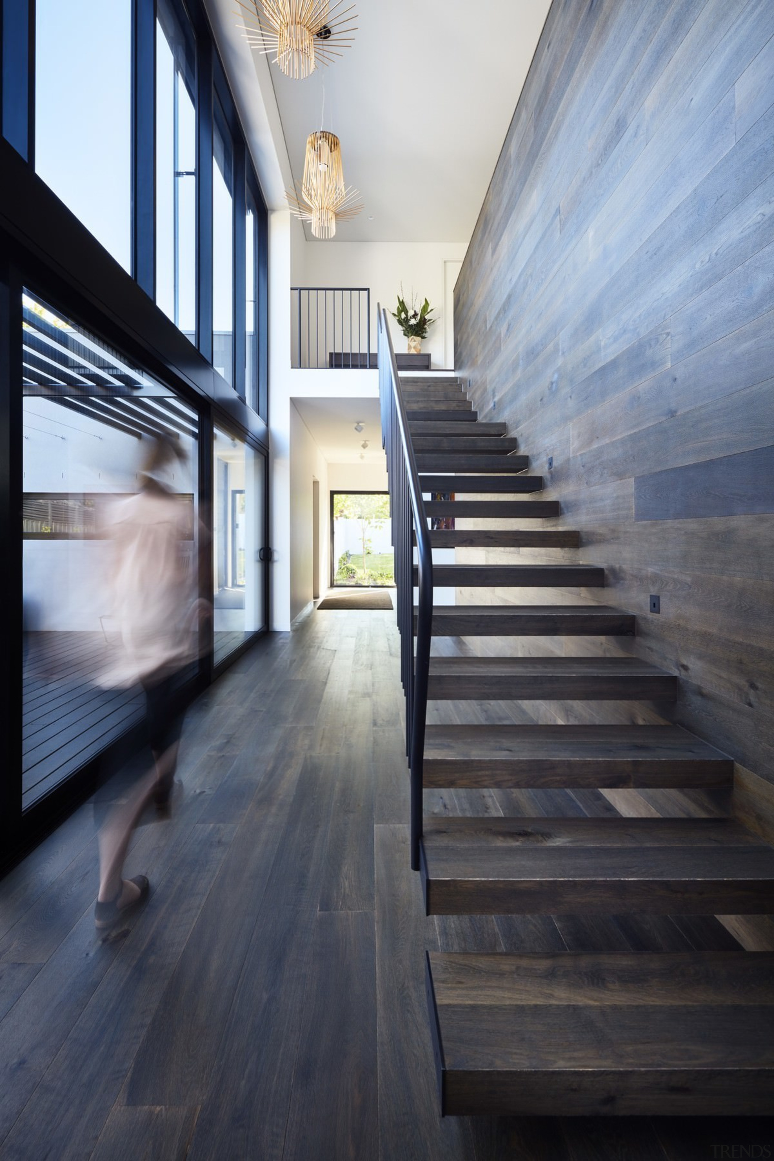 This wood staircase floats up to the second apartment, architecture, daylighting, floor, flooring, hardwood, home, house, interior design, loft, real estate, stairs, wood, wood flooring, black, gray