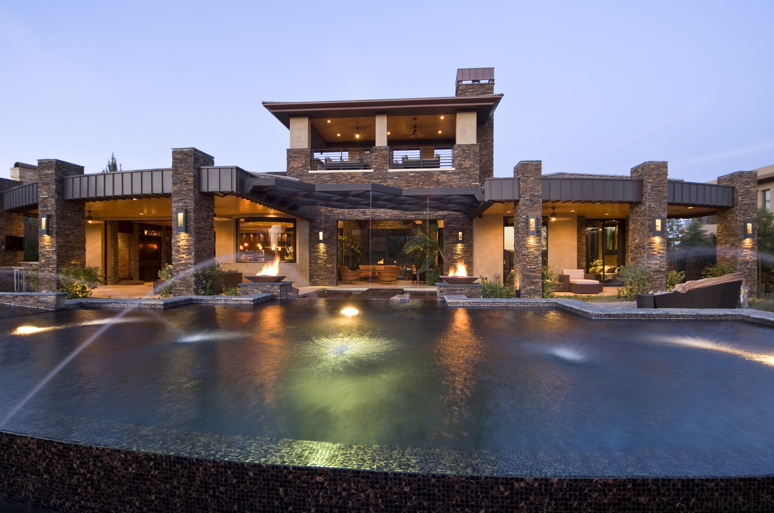 View of a grand Las Vegas Home that building, estate, hacienda, home, house, lighting, mansion, property, real estate, reflection, residential area, resort, swimming pool, villa, water, teal, black