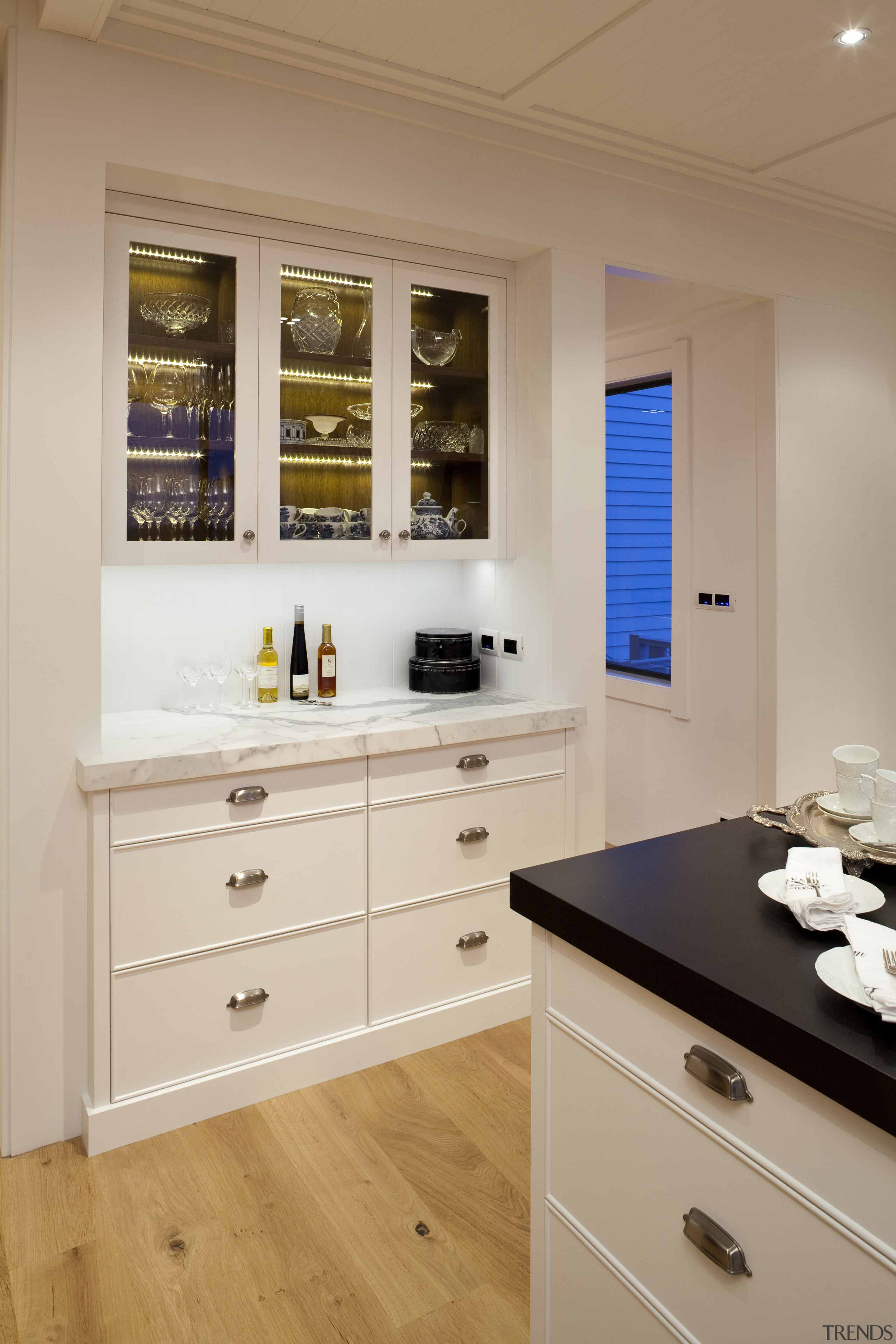 View of kitchen with wooden flooring, white cabinetry cabinetry, countertop, interior design, kitchen, room, gray