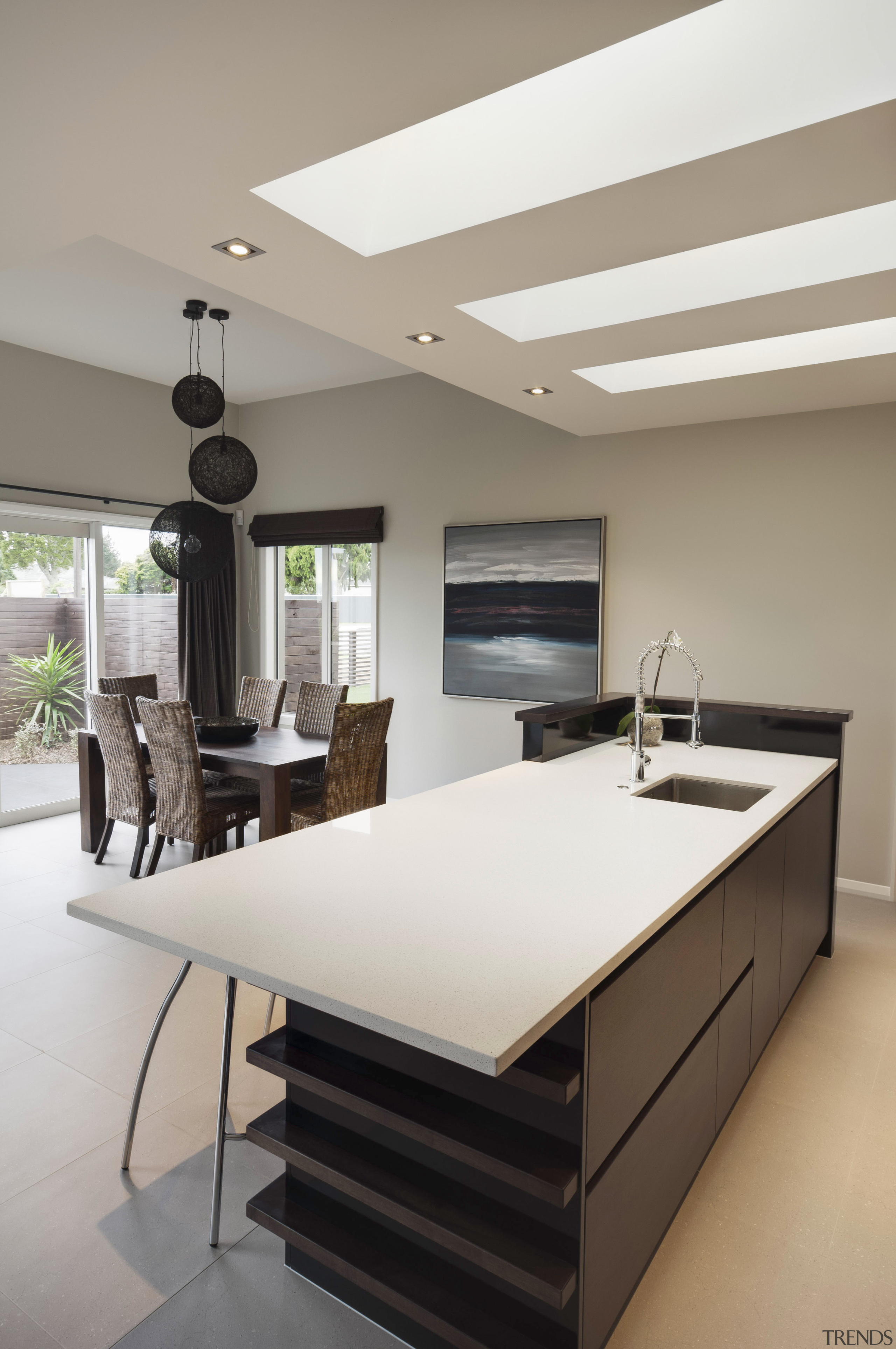 View of contemporary open plan interior with neutral-toned architecture, ceiling, countertop, floor, furniture, interior design, kitchen, product design, table, gray