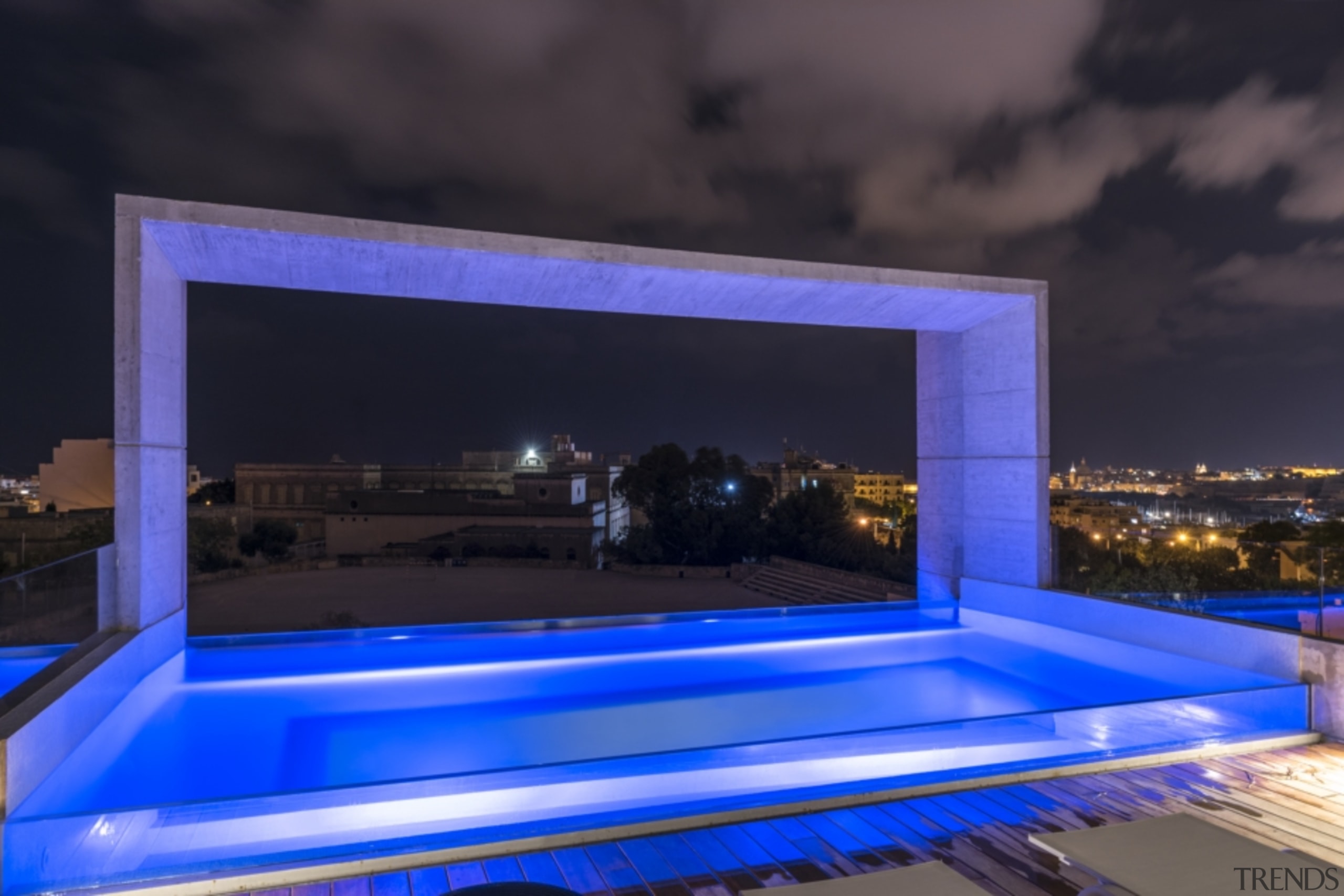 After dark, the pool takes on a party-like architecture, blue, building, design, home, house, interior design, lighting, majorelle blue, night, property, rectangle, room, sky, swimming pool, black, blue