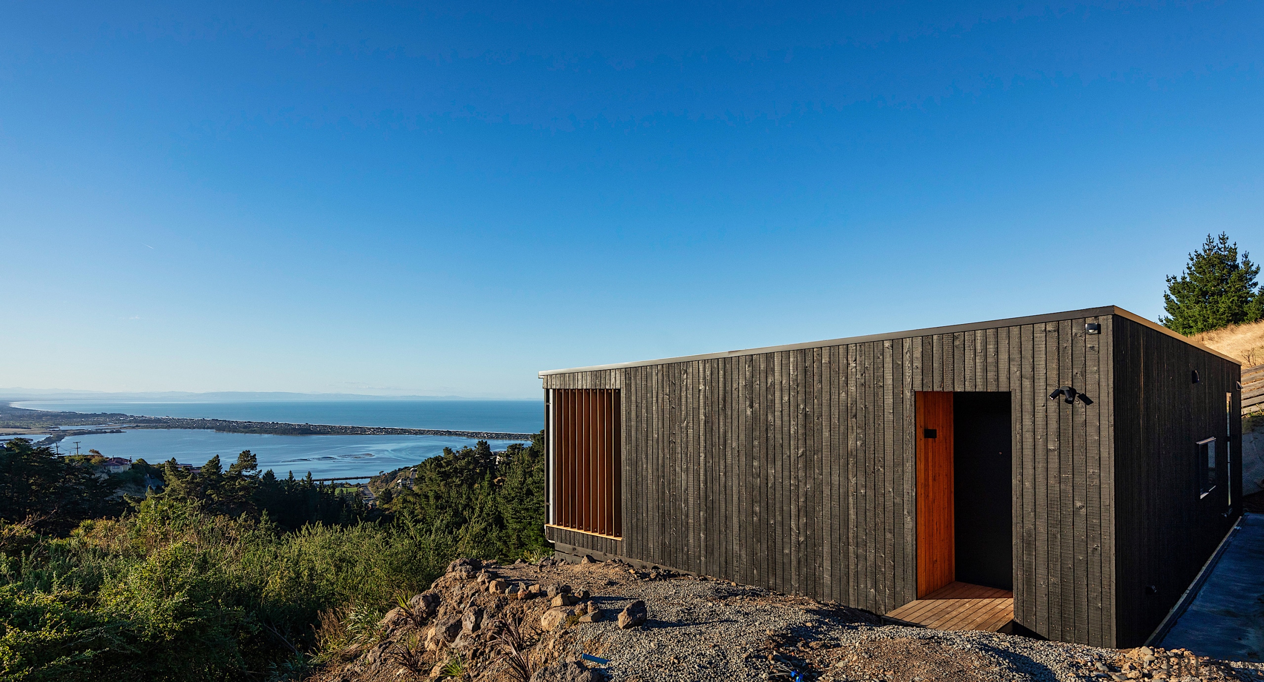 Burnt larch cladding – with cedar inlays – 