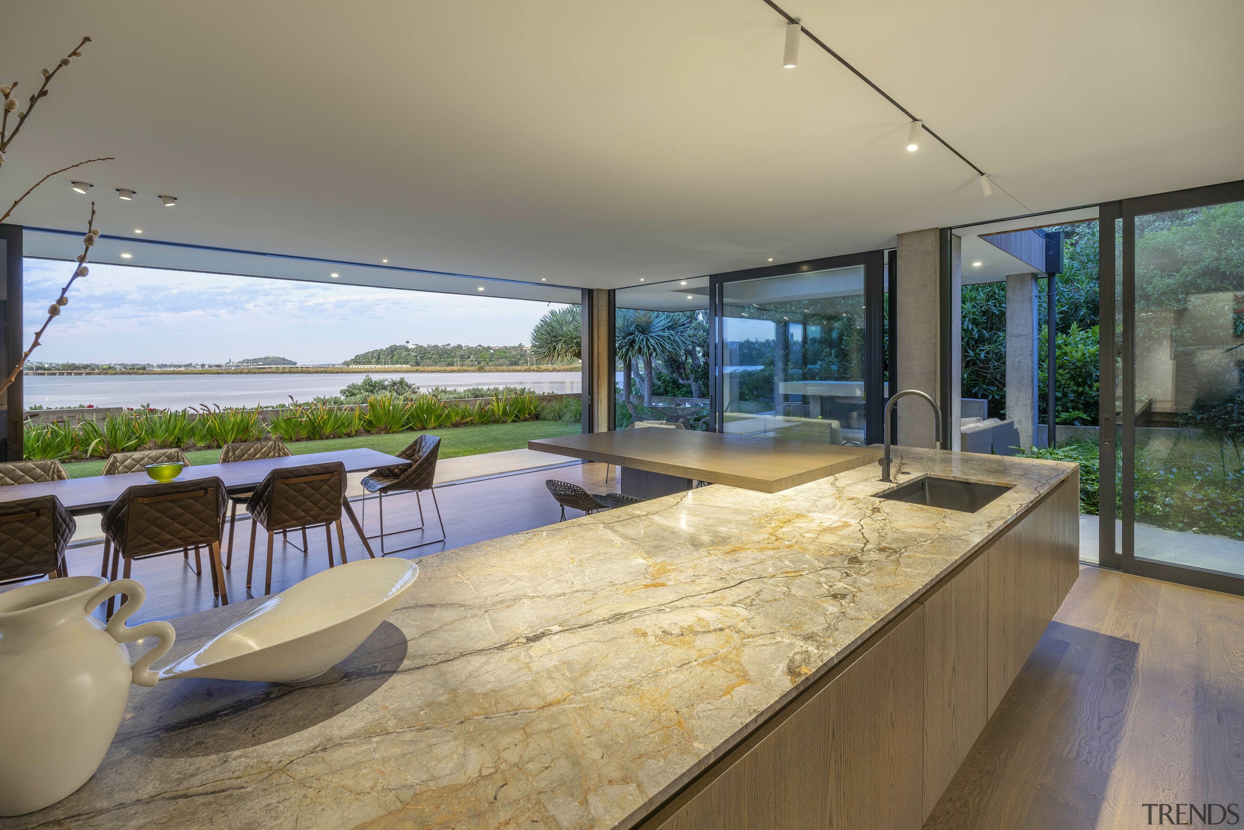 A warm-toned, slender stone benchtop is a feature. 