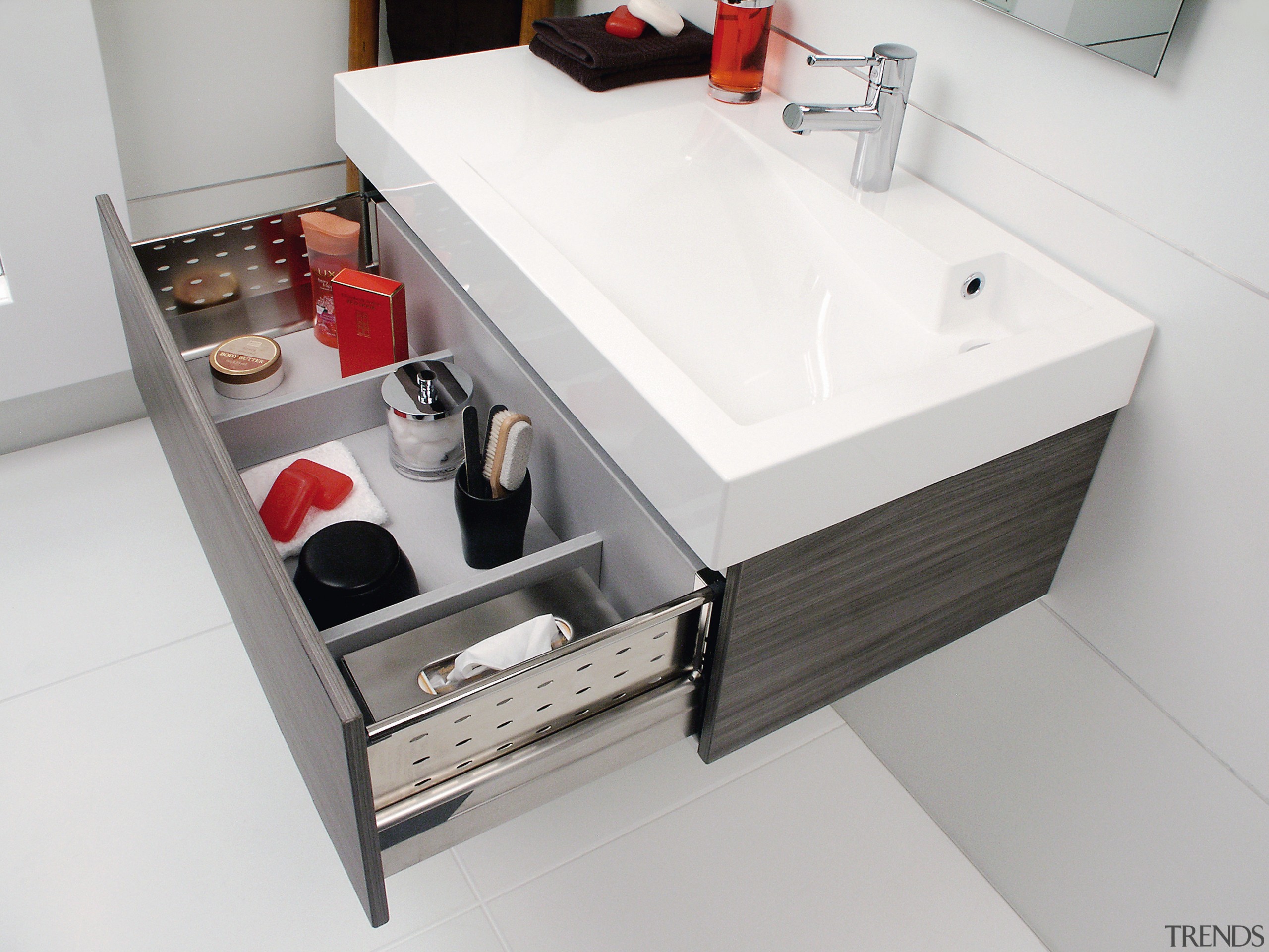 View of this bathroom featuring white cabinetry, stainless bathroom, bathroom accessory, bathroom cabinet, bathroom sink, drawer, furniture, plumbing fixture, product design, sink, white, gray