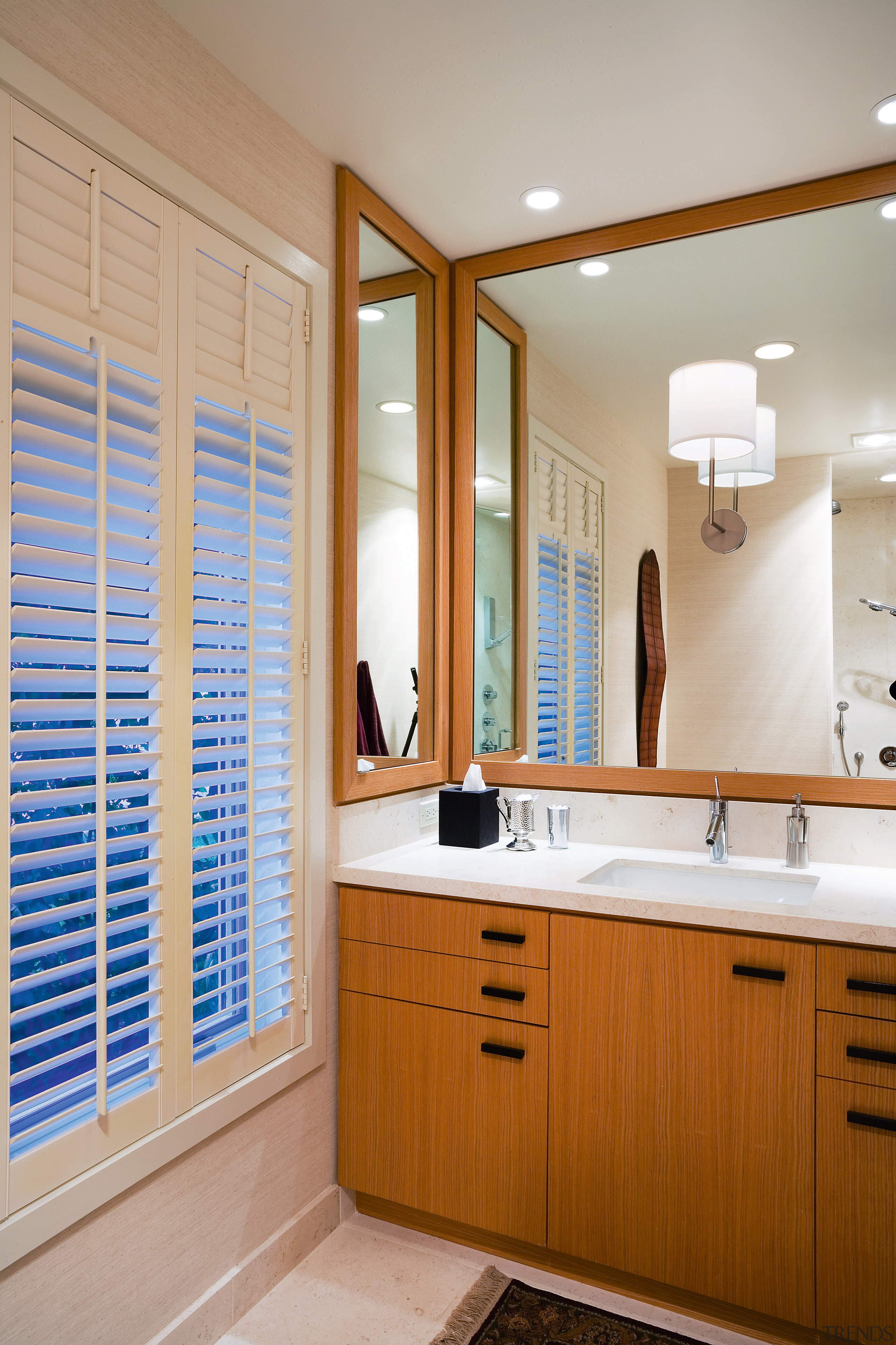 view of the bathroom featuring rift oak cabinetry, bathroom, bathroom accessory, bathroom cabinet, cabinetry, countertop, home, interior design, kitchen, room, window, gray, brown