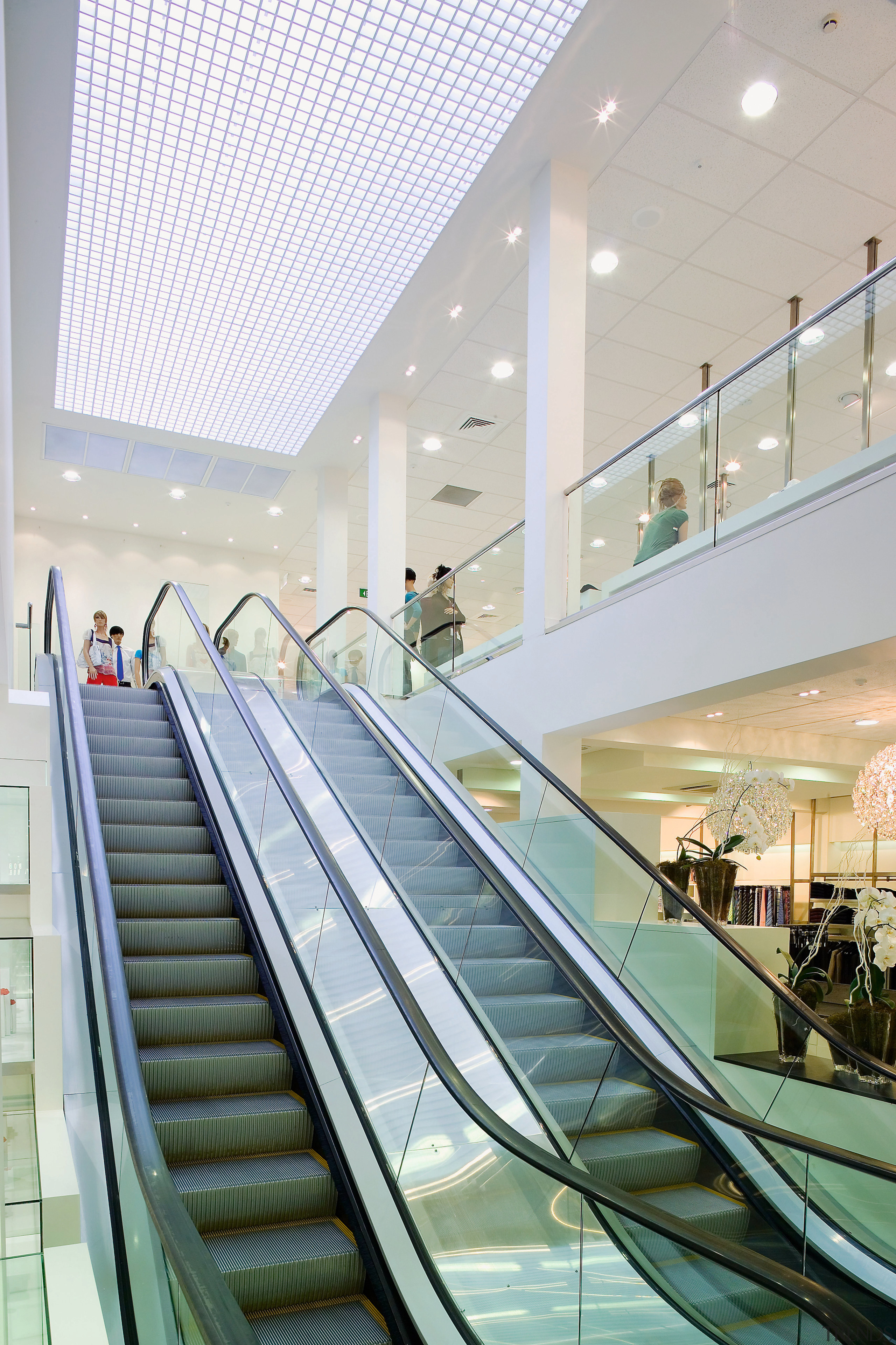 A view of some work by Amstar Construction. architecture, building, ceiling, daylighting, escalator, glass, handrail, interior design, leisure centre, lobby, shopping mall, stairs, structure, white, gray