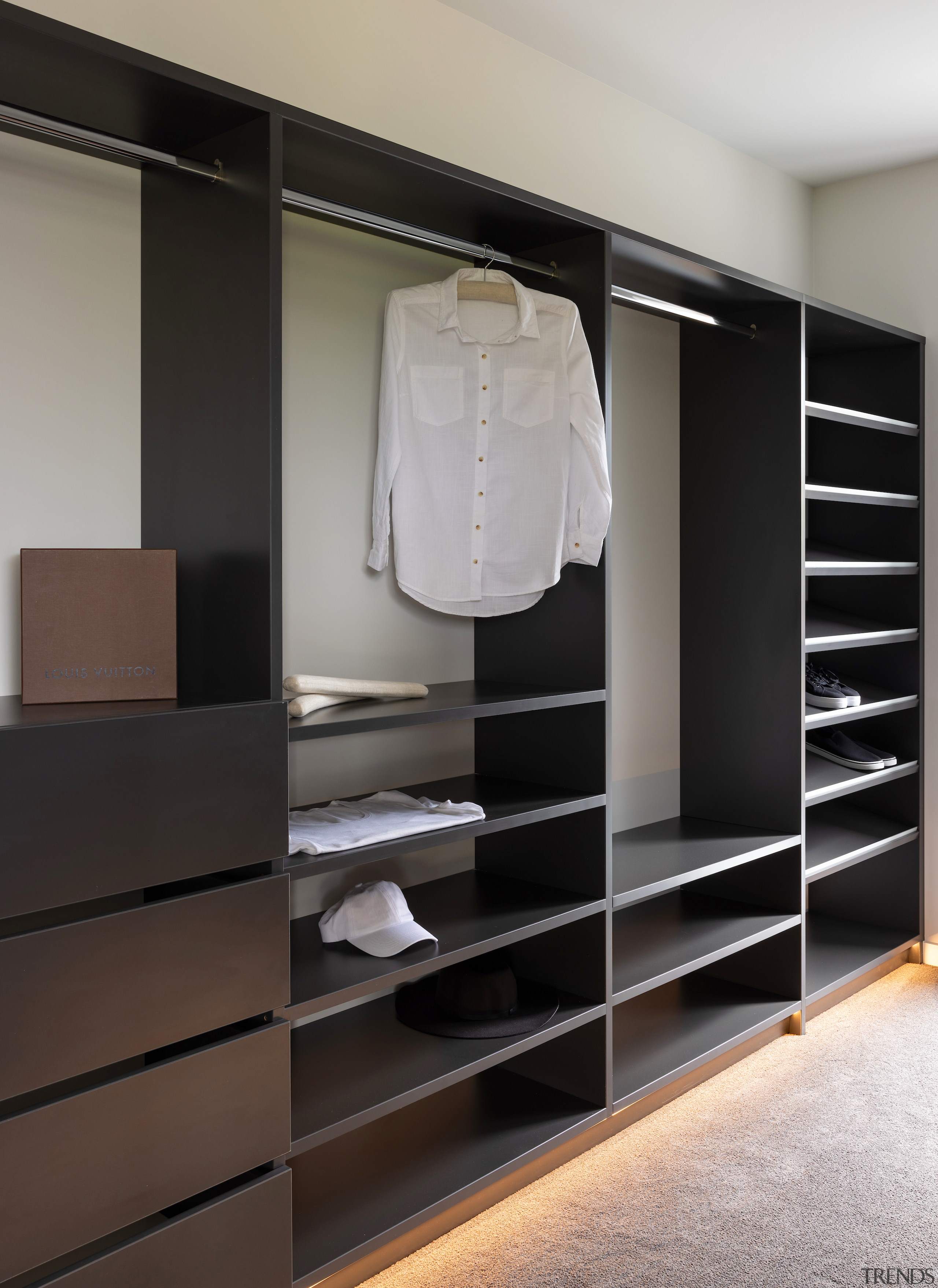 The walk-in robe features custom wood cabinetry with 