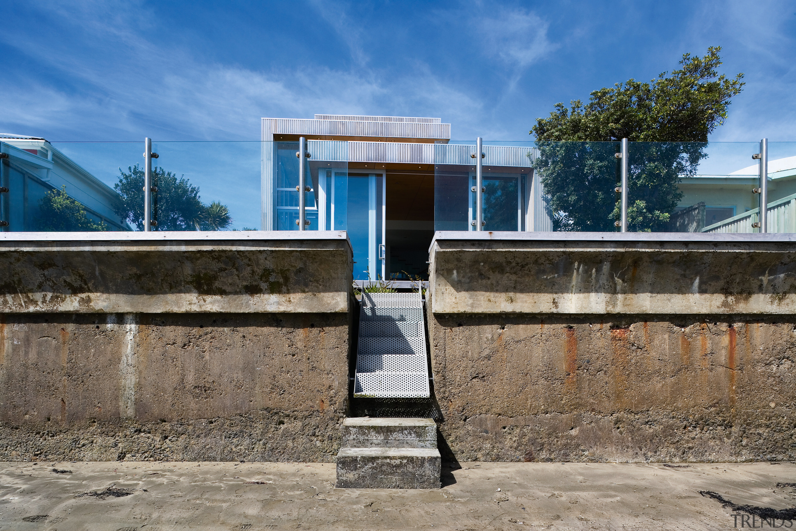 An exterior view of this house that features architecture, building, real estate, sky, structure, water, teal