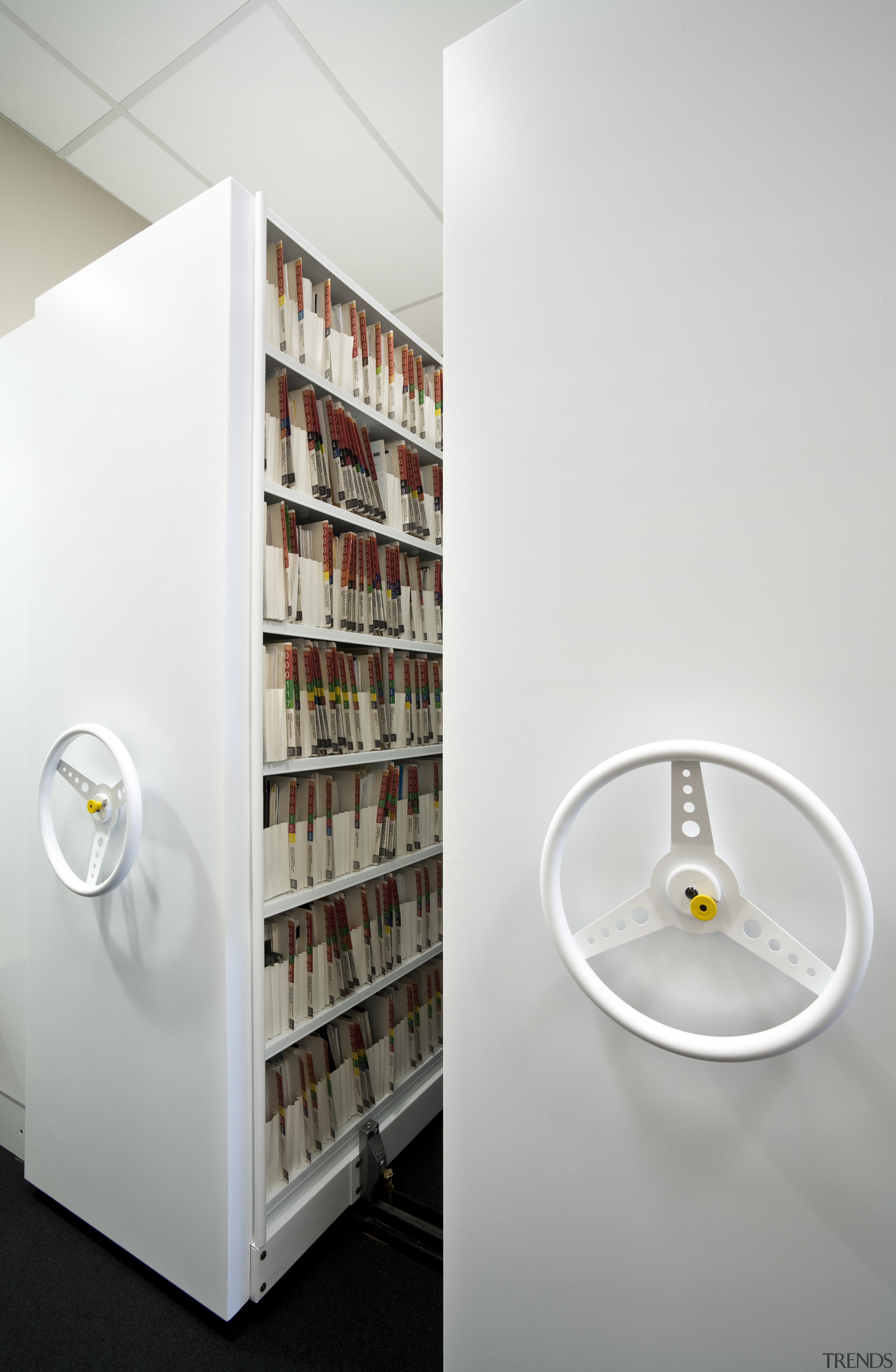 View of adjustable storage shelves with lockable handwheels. furniture, product design, shelf, shelving, white