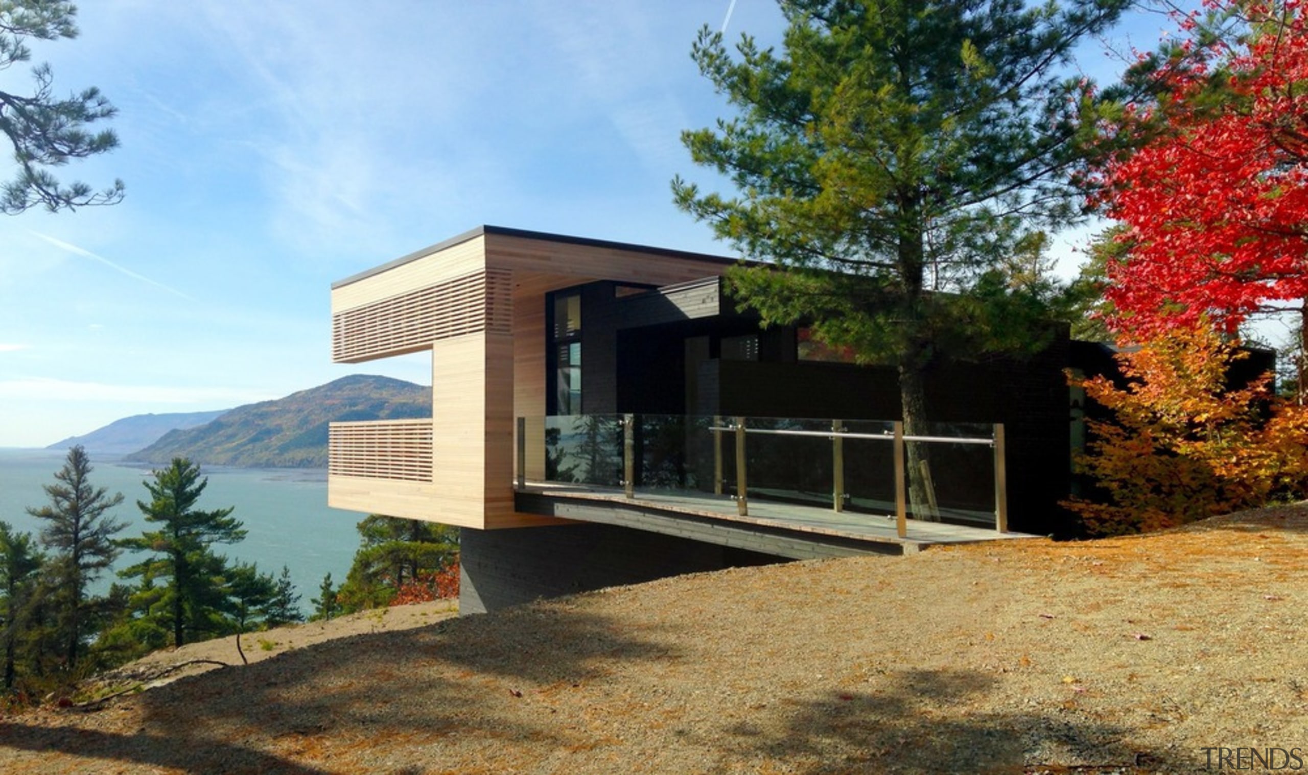 Sited high above Canada's St Lawrence river, this architecture, building, cottage, design, facade, home, house, landscape, property, real estate, room, tree