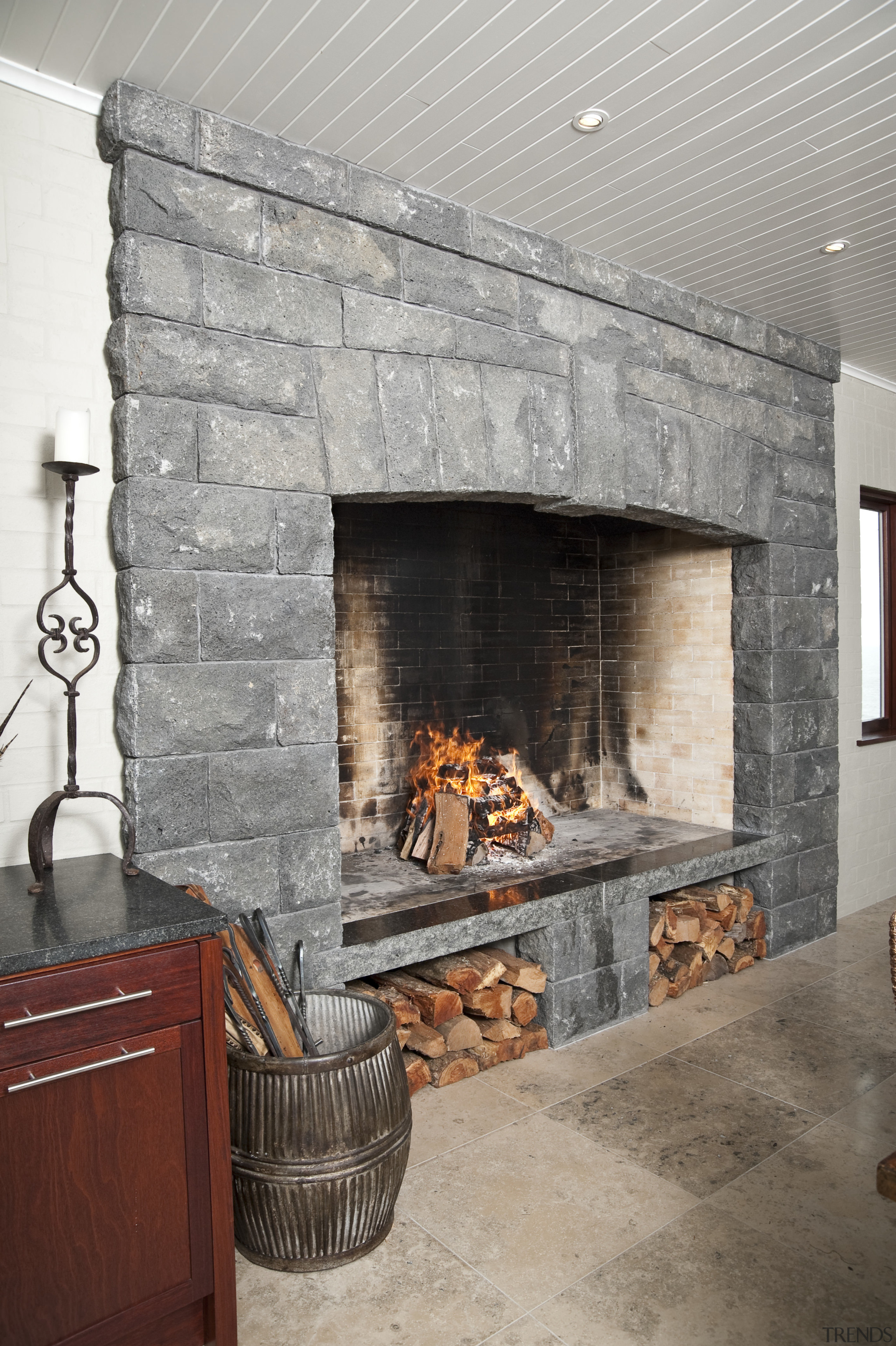 In the dining area of the home this fireplace, floor, hearth, interior design, living room, masonry oven, wall, wood burning stove, gray