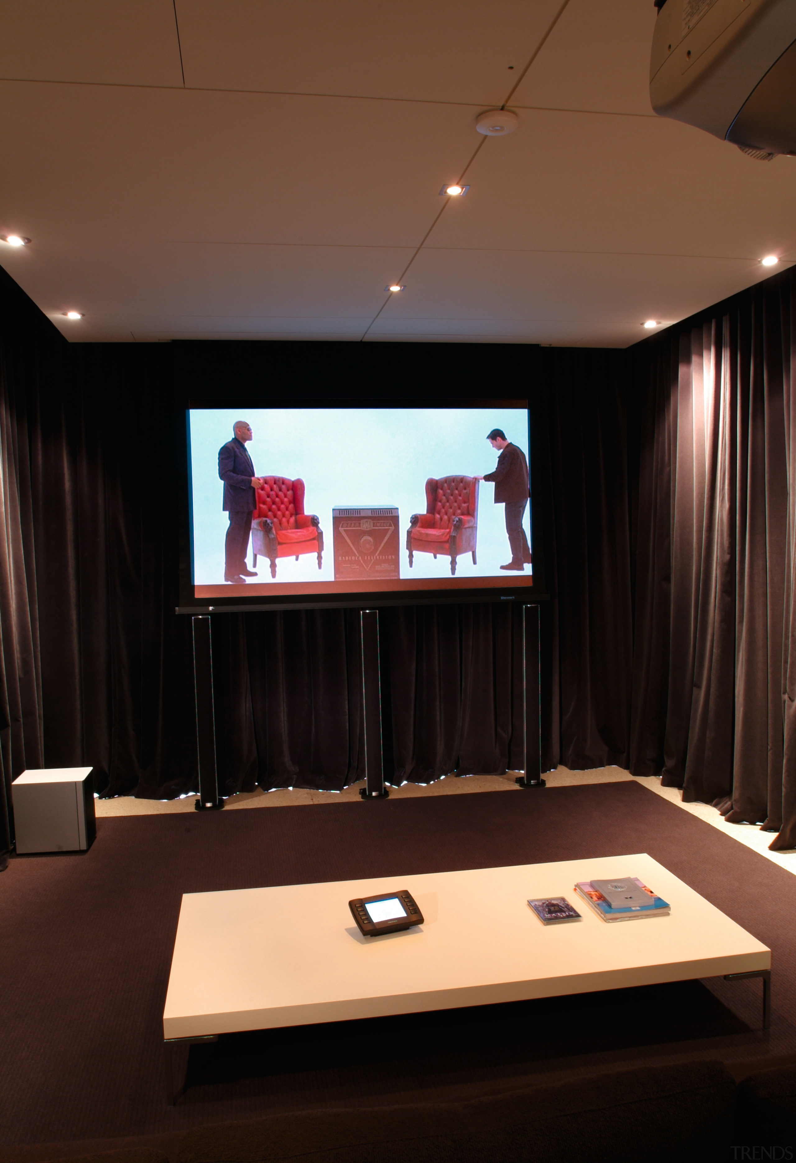 view of the home theatre area with motorised ceiling, conference hall, display device, furniture, interior design, room, table, black, brown
