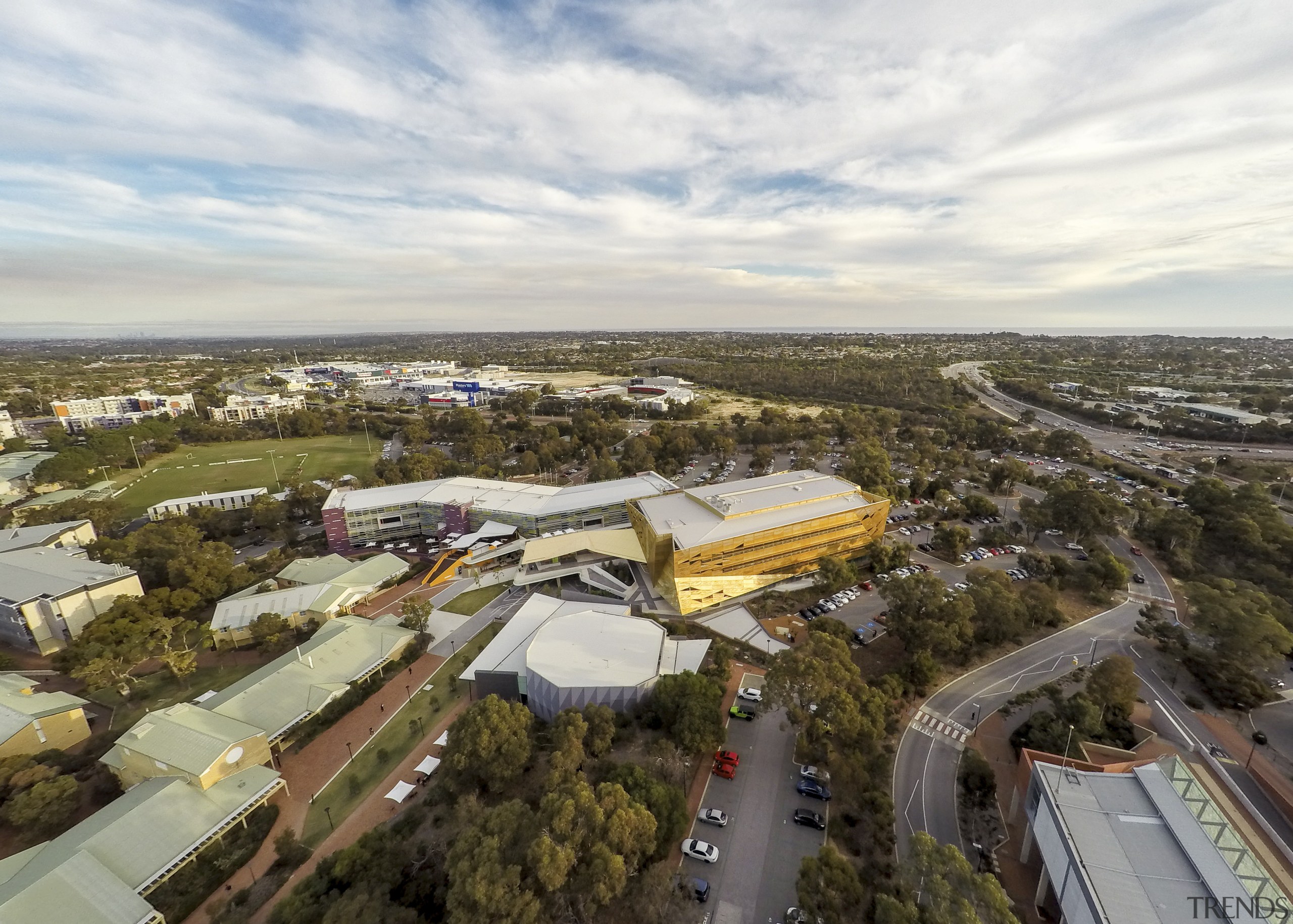 A golden canopy and veil enliven the exterior aerial photography, bird's eye view, city, real estate, sky, suburb, white, brown