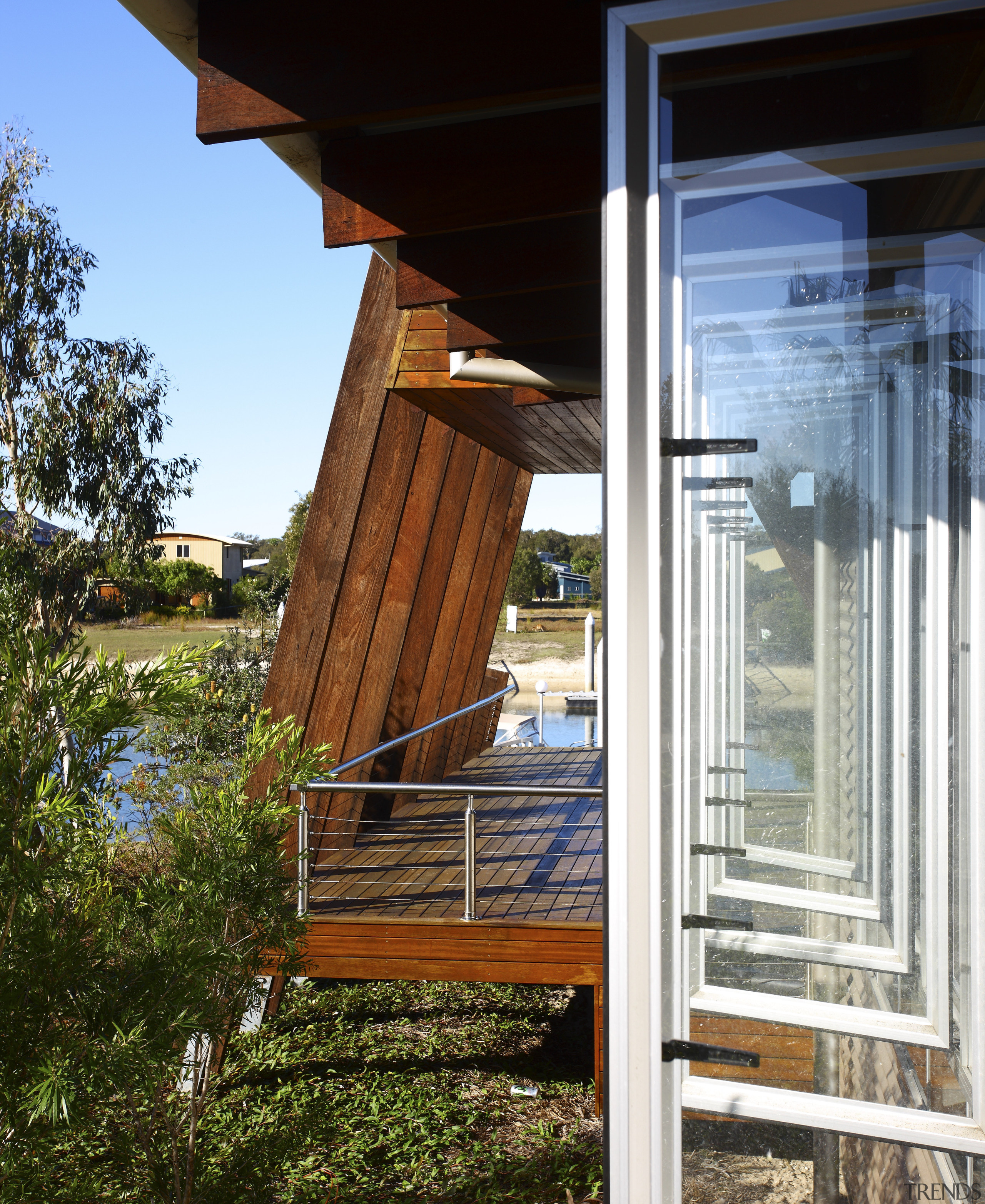 Exterior view of one of the decks with architecture, deck, facade, home, house, outdoor structure, porch, siding, wood, brown