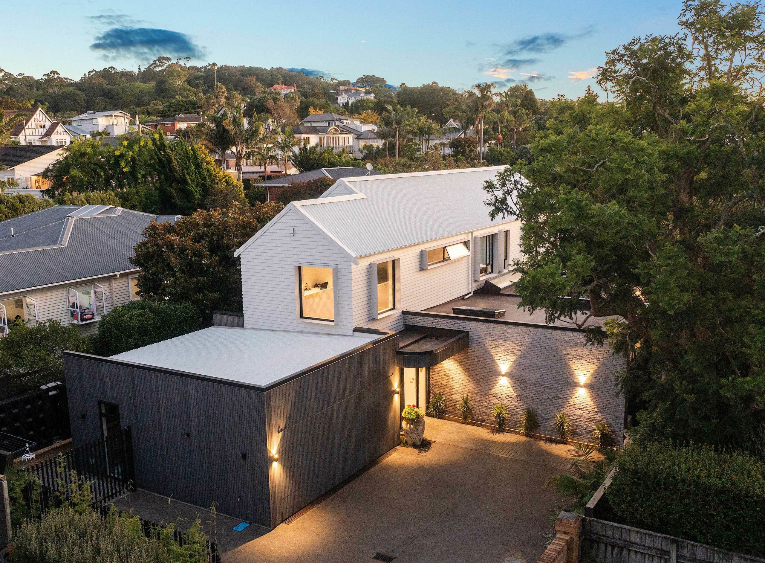 The expansive fusion-style home at dusk. - Villa 