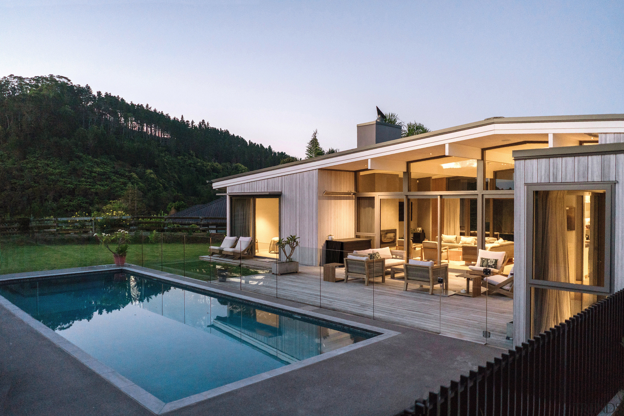 Wall of glass looks out on pool. - 