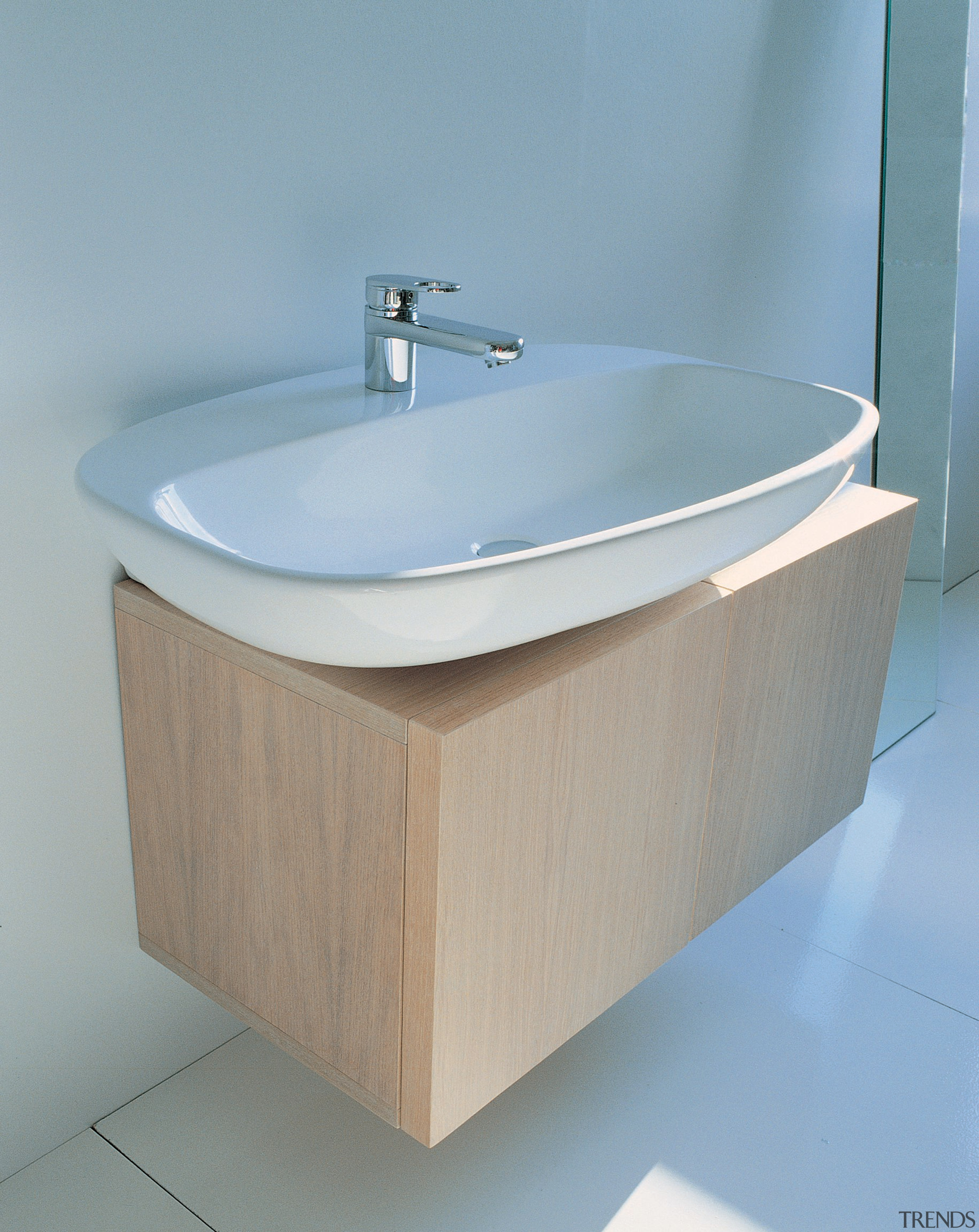 Bathroom: Large semi-circular basin sitting atop a lighty angle, bathroom, bathroom accessory, bathroom cabinet, bathroom sink, plumbing fixture, product design, sink, tap, toilet seat, gray