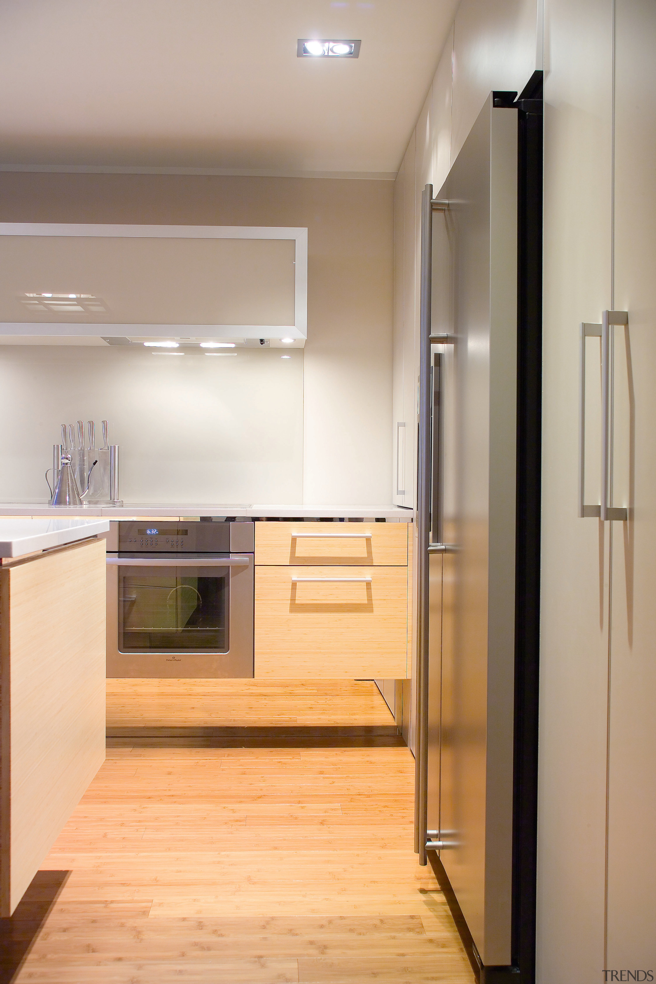 view of the kitchen featuring bamboo flooring, Techistone cabinetry, countertop, floor, flooring, hardwood, home appliance, interior design, kitchen, room, gray, orange