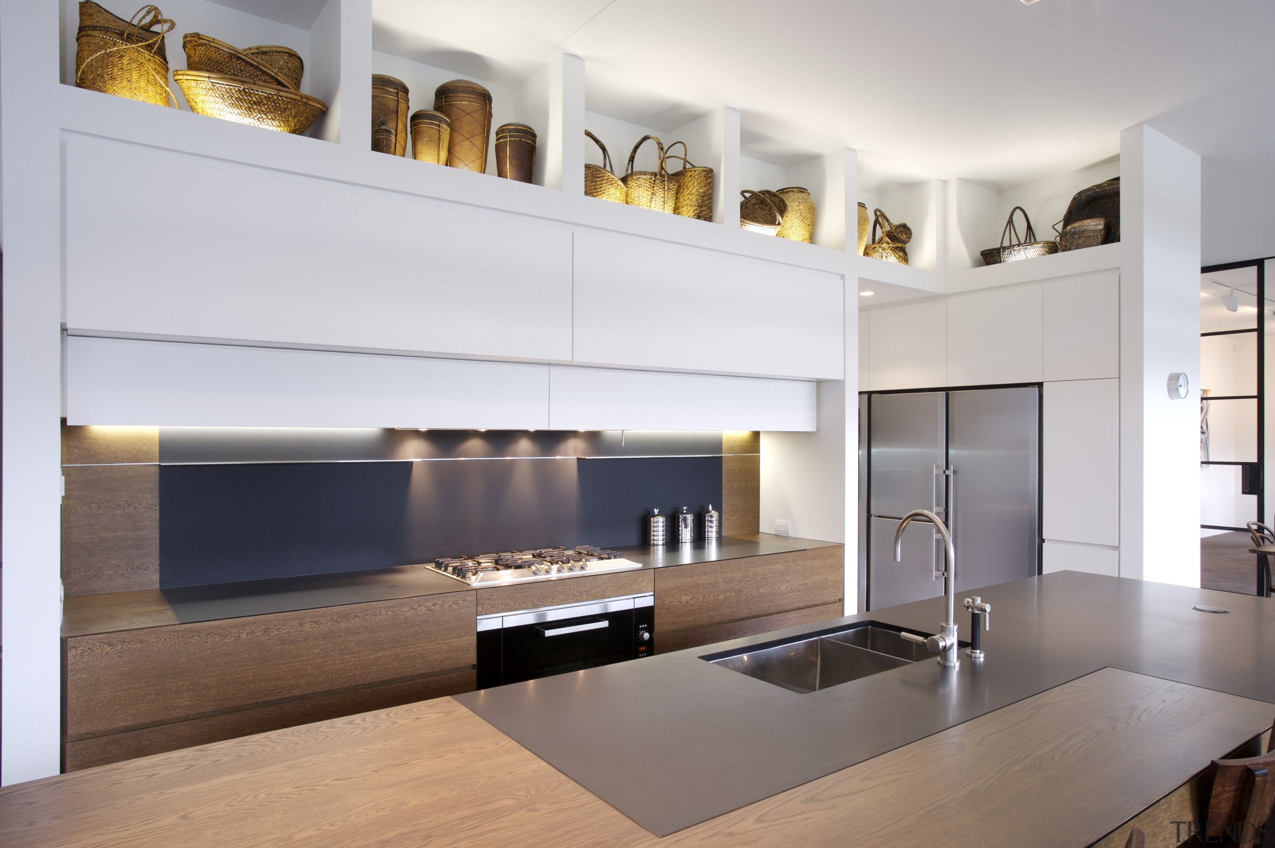 View of kitchen which features oak veneer island cabinetry, countertop, floor, interior design, interior designer, kitchen, living room, room, white