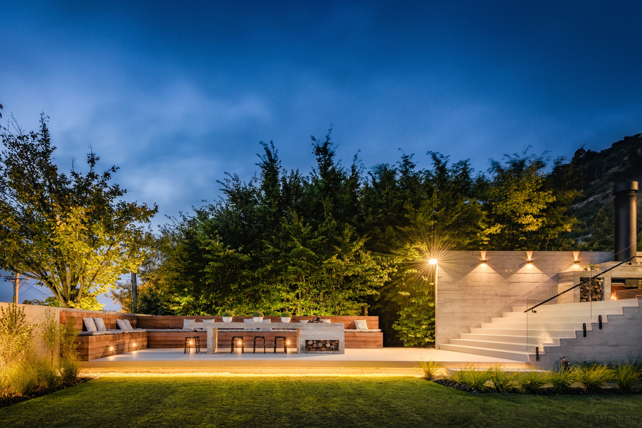 ​​​​​​​This home by designers Marcus Freeman and Hayden architecture, building, cloud, estate, facade, grass, home, house, land lot, landscape, landscape lighting, landscaping, light, lighting, night, property, real estate, residential area, sky, tree, yard, brown