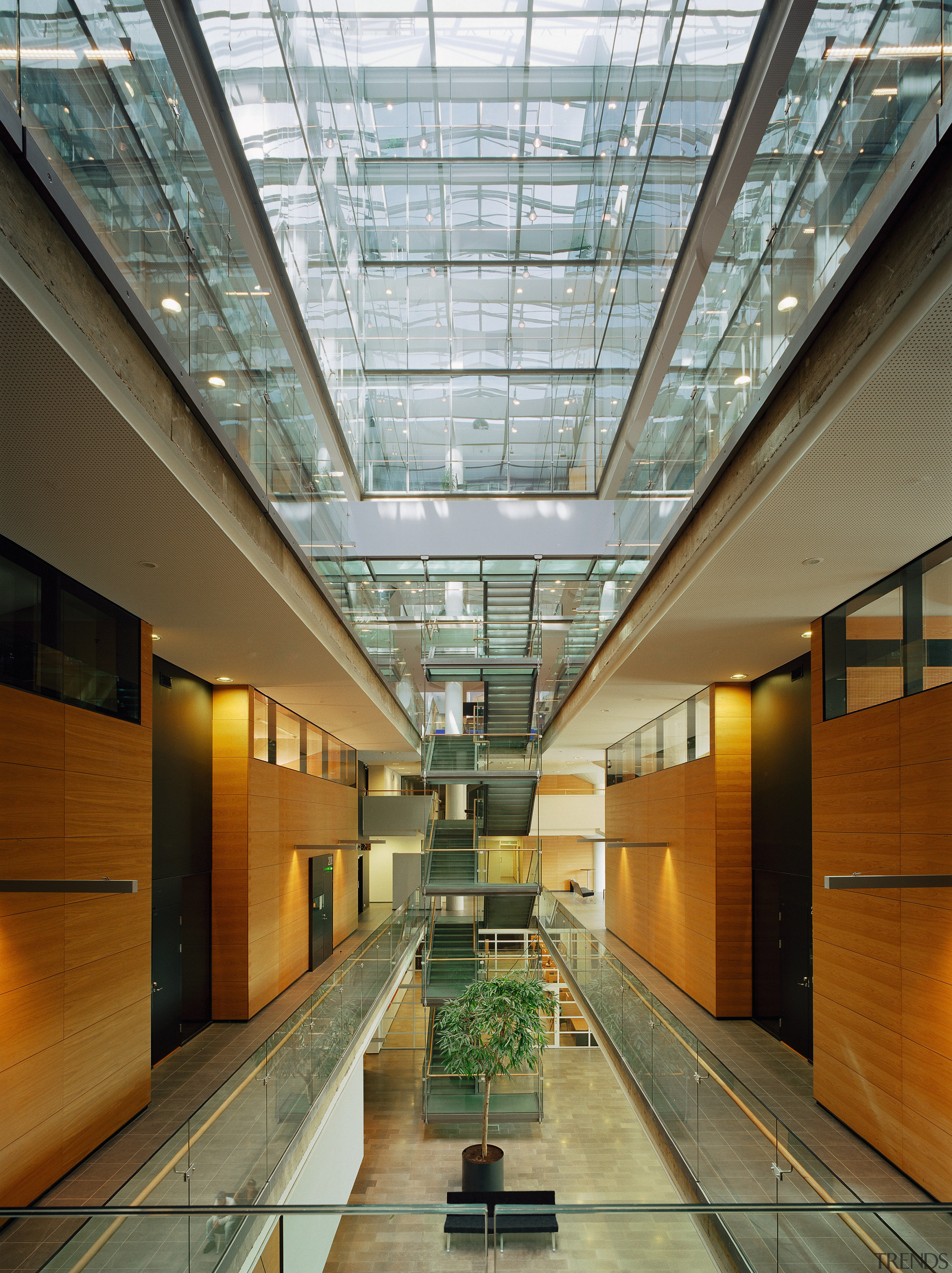 An interior view of the building. - An apartment, architecture, ceiling, condominium, daylighting, glass, headquarters, interior design, lobby, metropolitan area, real estate, brown, gray