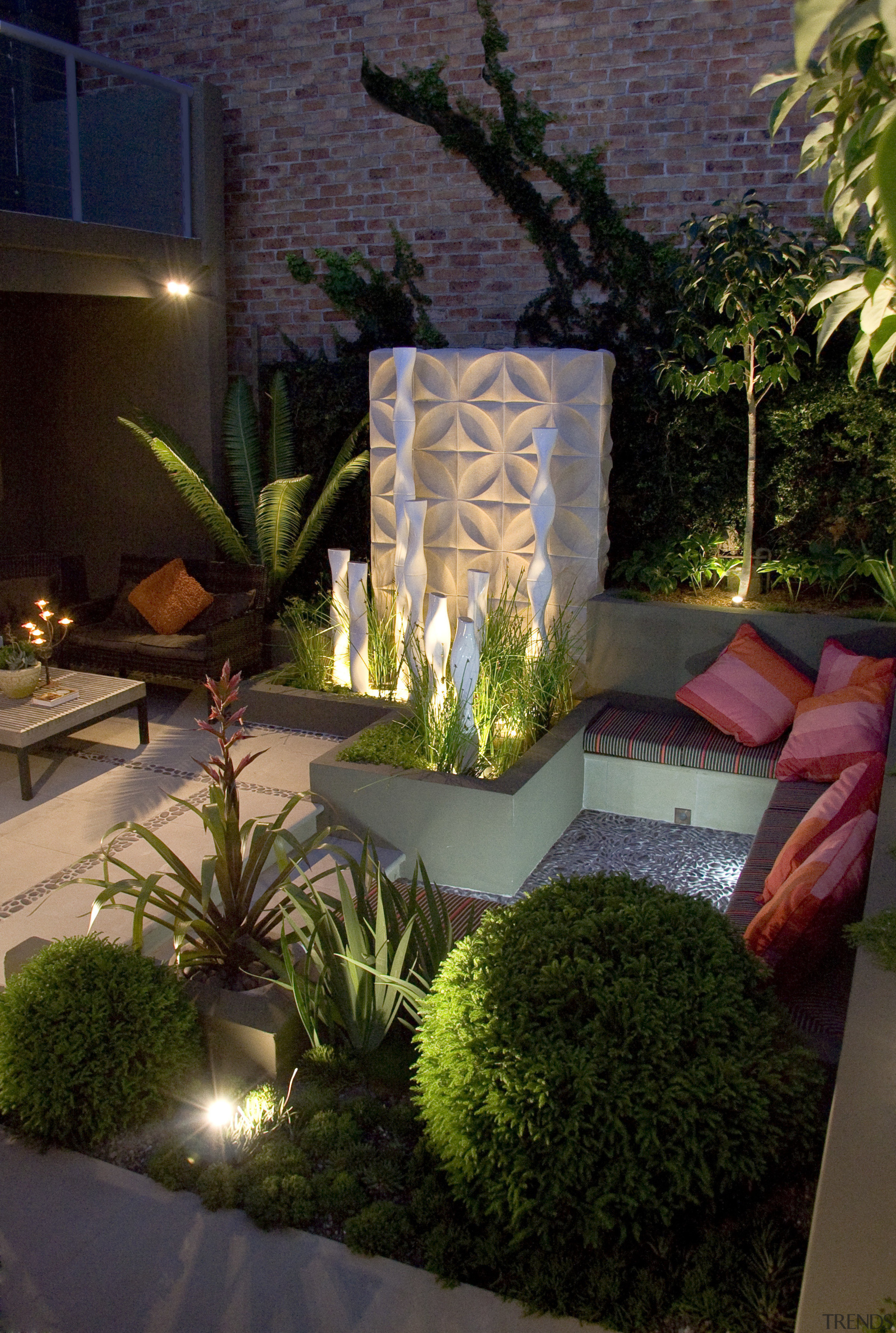 View of outdoor living area and courtyard featuring backyard, courtyard, garden, home, landscape lighting, landscaping, lighting, majorelle blue, outdoor structure, plant, yard, black, brown