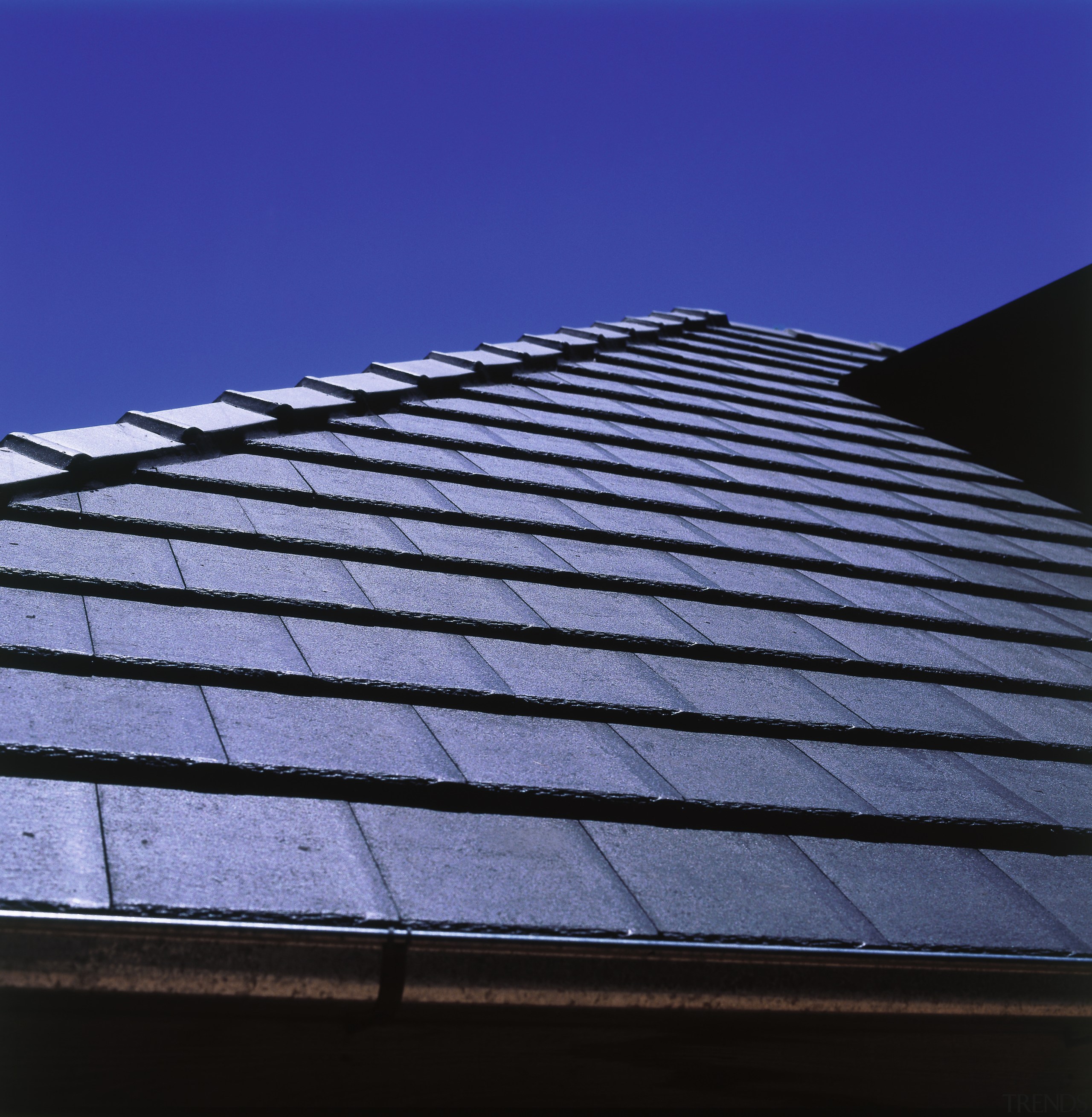 Close-up of roof showing grey shingle tiles and angle, architecture, building, cloud, daylighting, daytime, facade, landmark, line, roof, sky, sunlight, blue, black