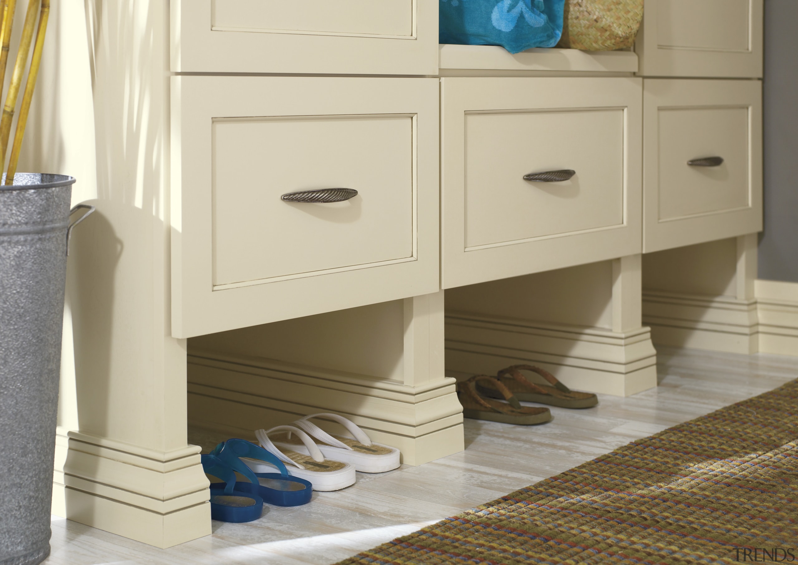 View of a bedroom which features cabinetry from cabinetry, chest of drawers, drawer, floor, flooring, furniture, product, product design, sideboard, wood stain, orange, brown