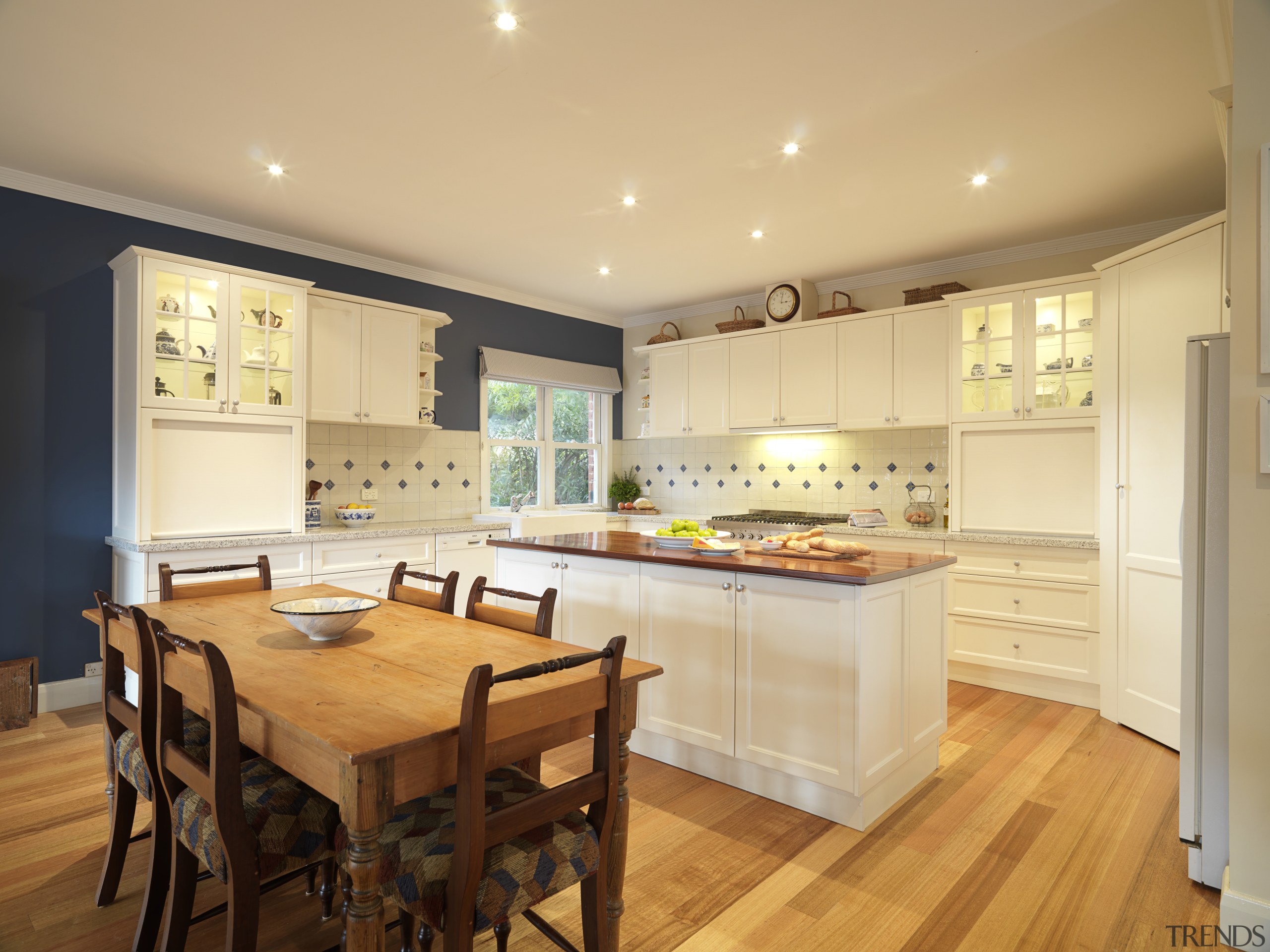 Antique-white cabinets with simply styled panel doors bring cabinetry, ceiling, countertop, cuisine classique, flooring, interior design, kitchen, real estate, room, wood flooring, orange