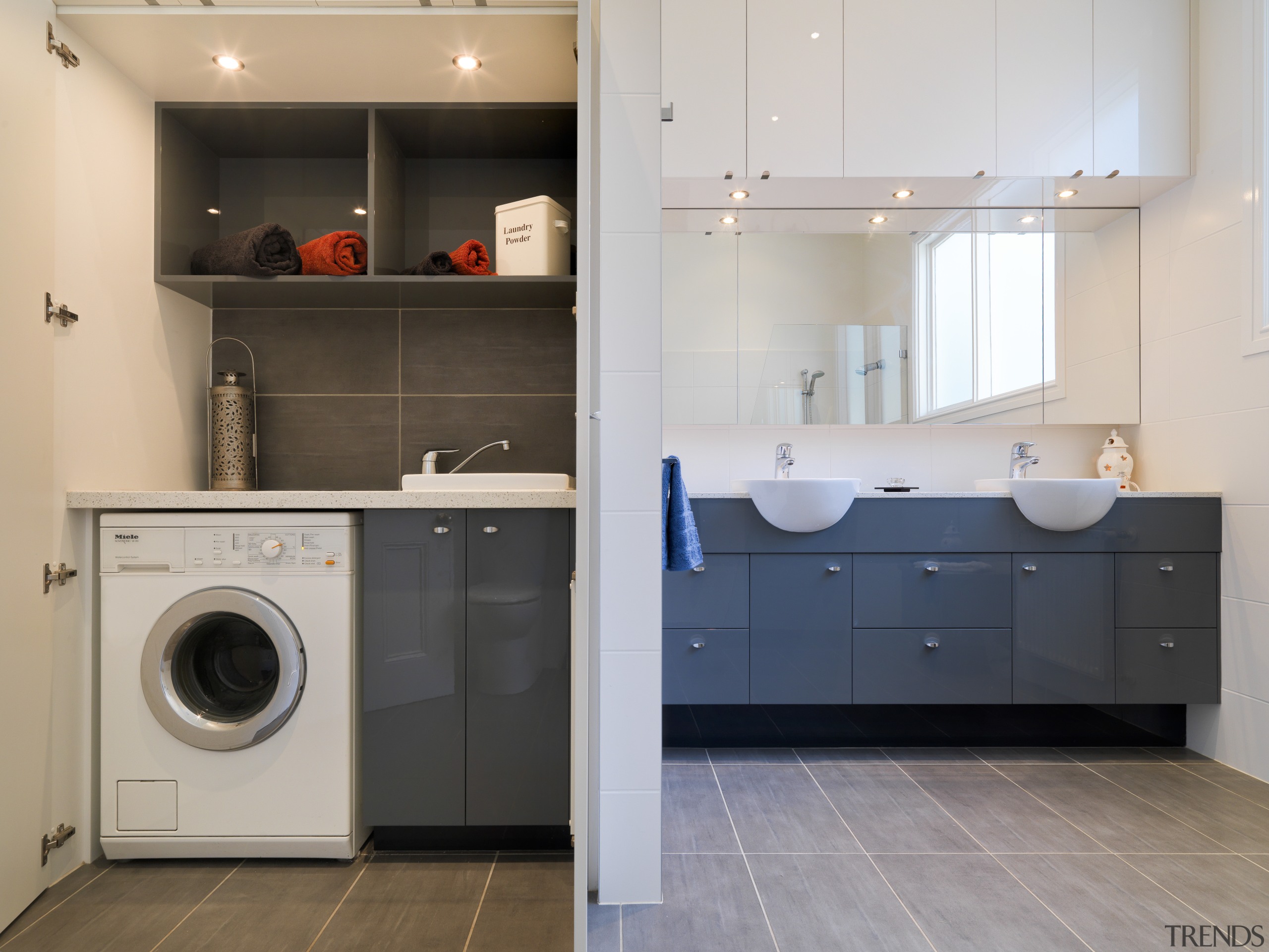 Laundry with grey tiled floor and blue cupboards, cabinetry, clothes dryer, countertop, home appliance, interior design, kitchen, laundry, laundry room, major appliance, product design, room, washing machine, gray