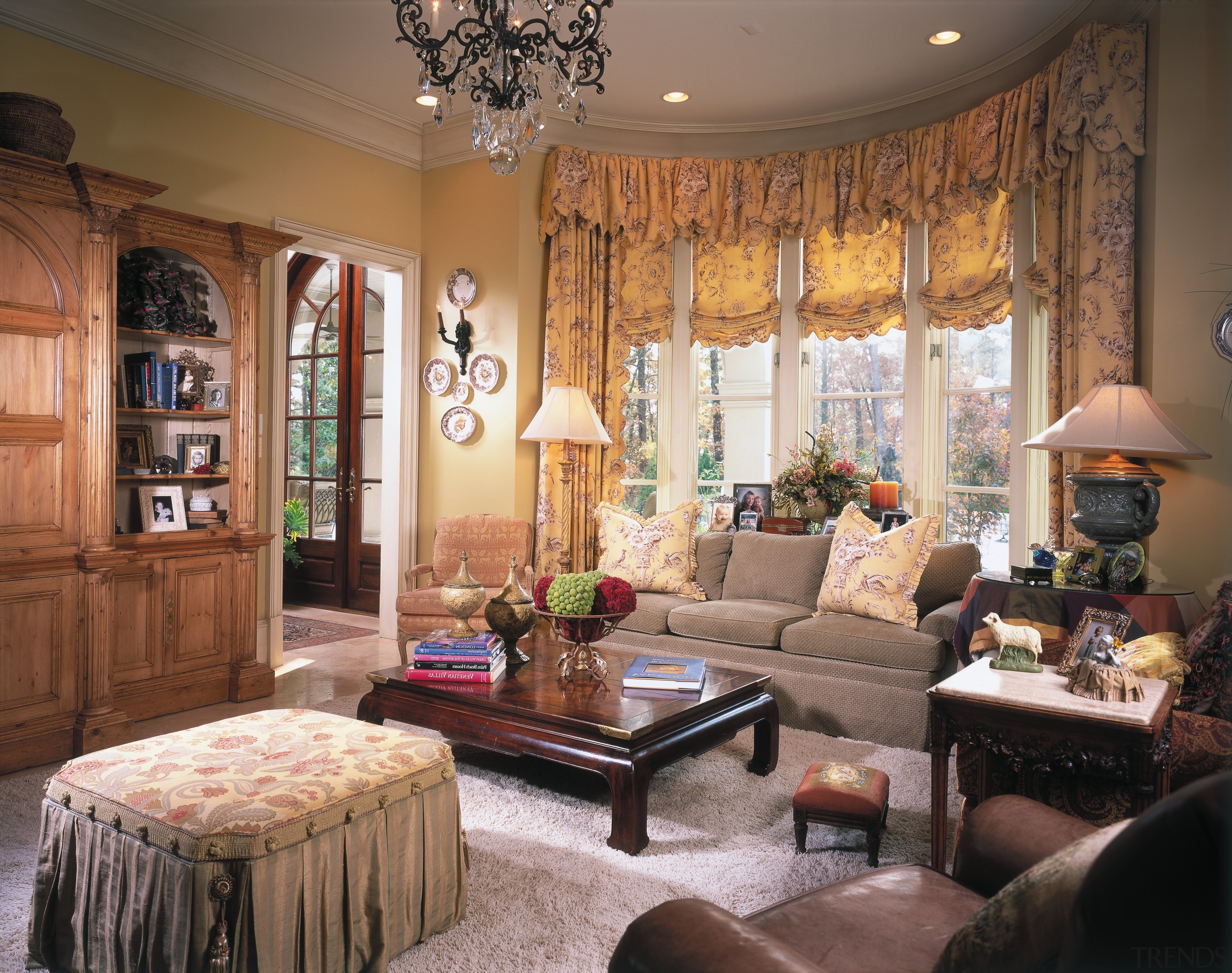 The sunroom adjoins the breakfast room. The curved ceiling, furniture, home, interior design, living room, room, window, window treatment, brown