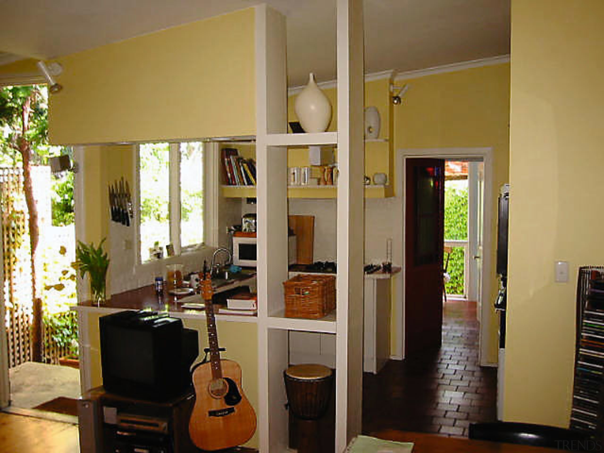 The previously box-like kitchen area has been opened door, furniture, home, interior design, room, window, brown