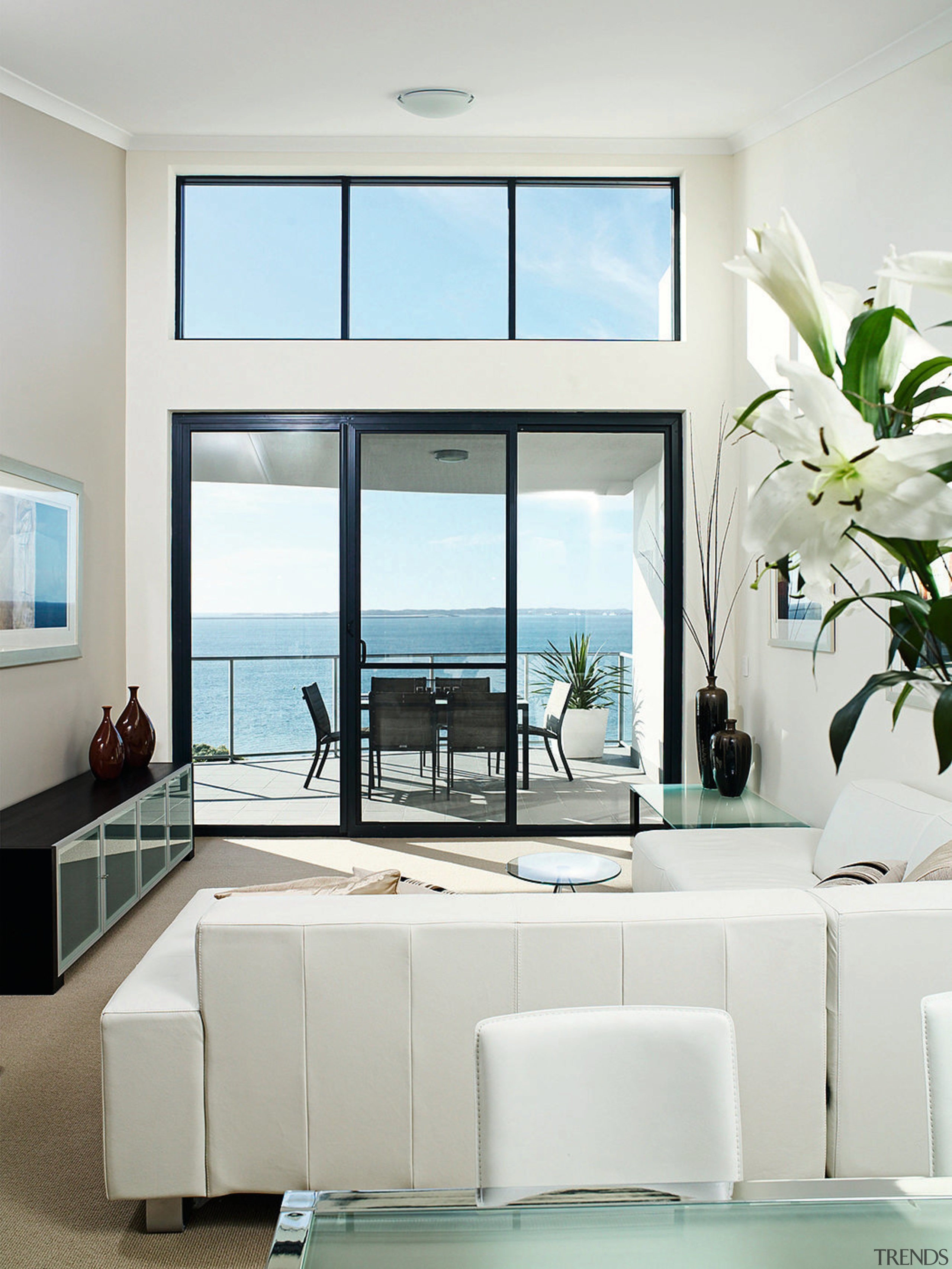 Large balconies allow homeowners to enjoy views of furniture, home, interior design, living room, table, window, white