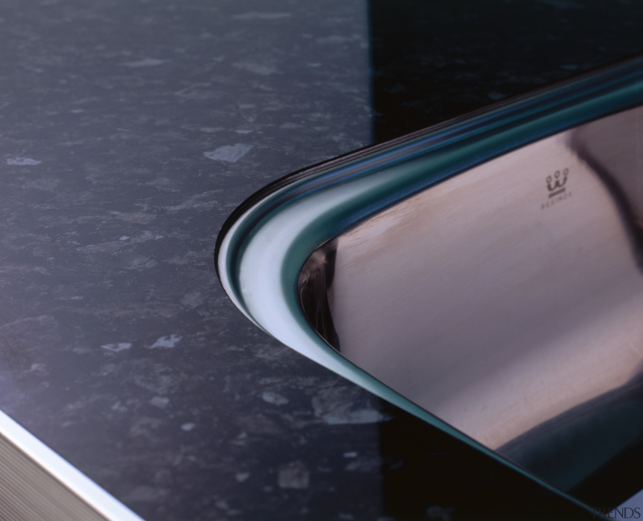 Closeup of stone-look benchtop and corner of sink. automotive design, automotive exterior, automotive mirror, bumper, eyewear, hood, line, product design, rear view mirror, reflection, vehicle door, windshield, gray, black