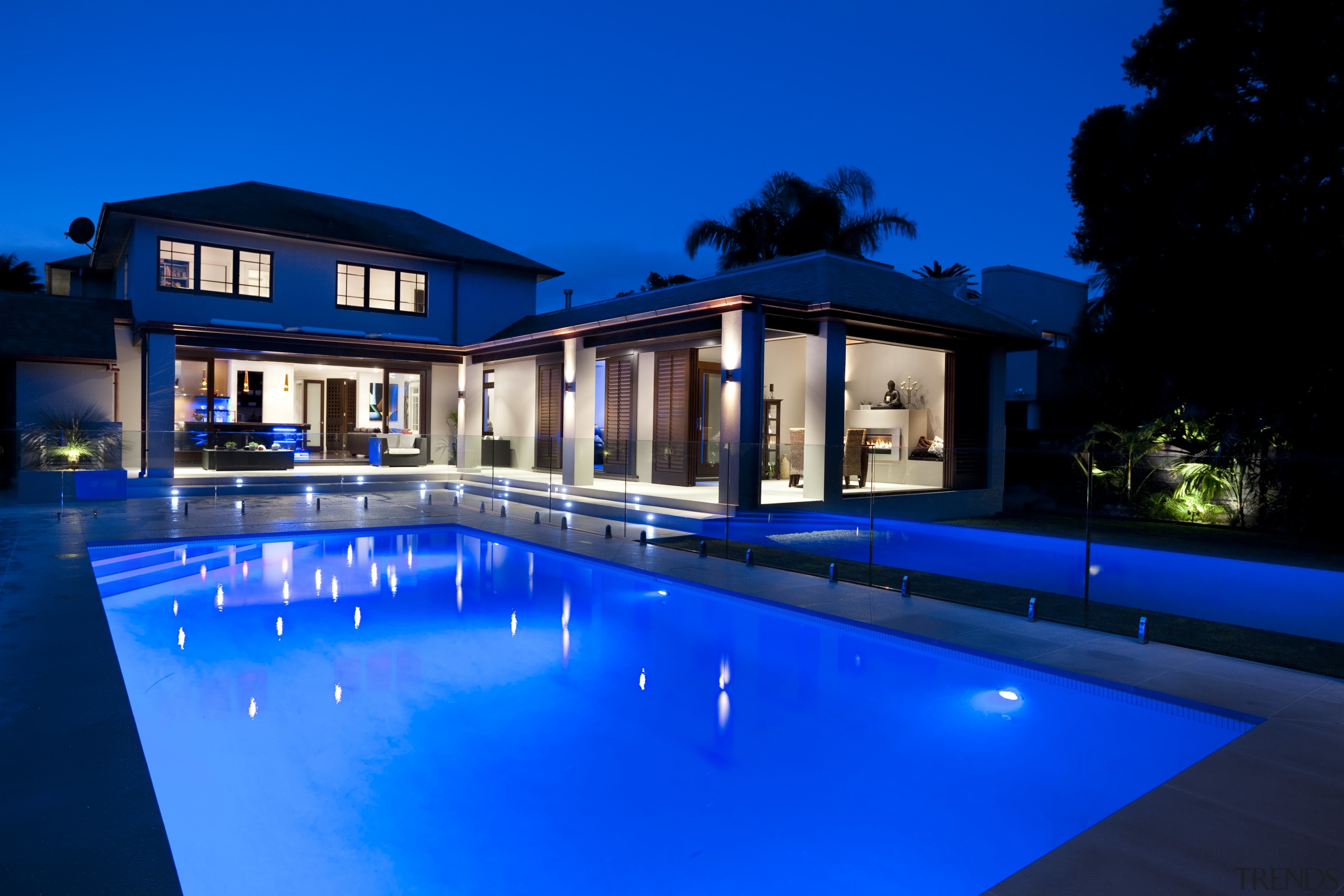 Outdoor night shot of contemporary house and pool architecture, estate, home, house, lighting, mansion, property, real estate, reflection, sky, swimming pool, villa, water, blue