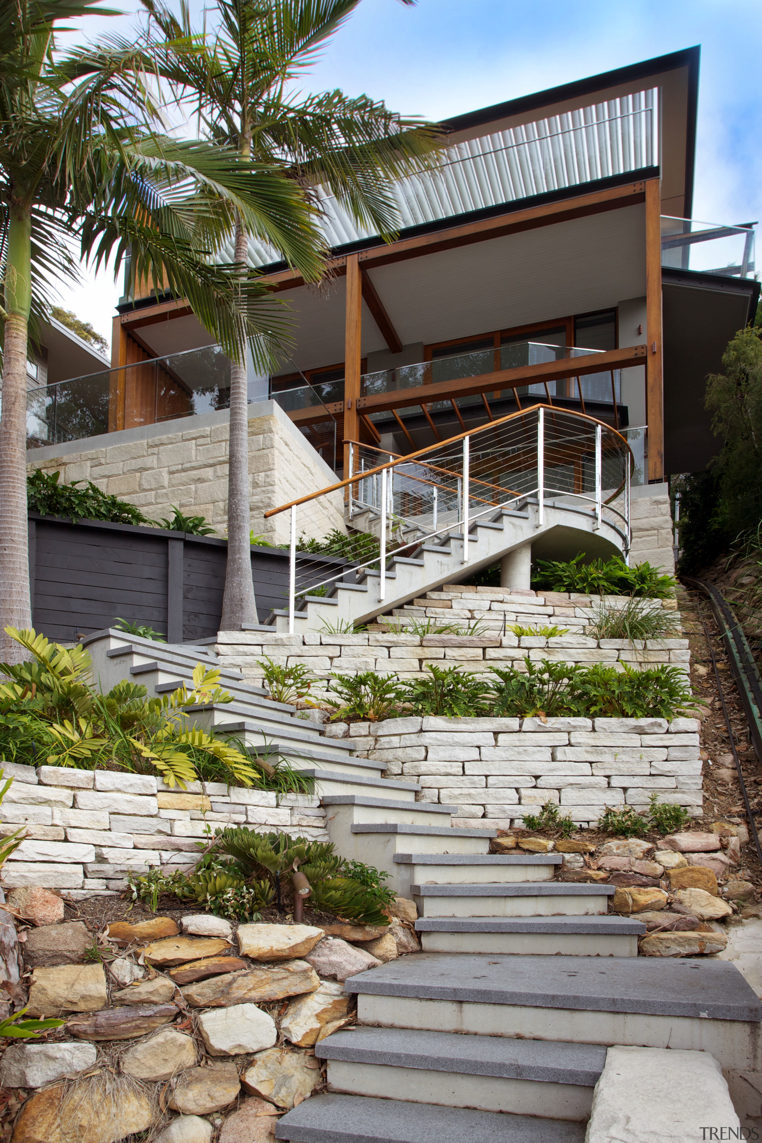 A series of zigzagging stone steps lead up architecture, courtyard, estate, facade, home, house, outdoor structure, real estate, residential area, walkway, gray, brown