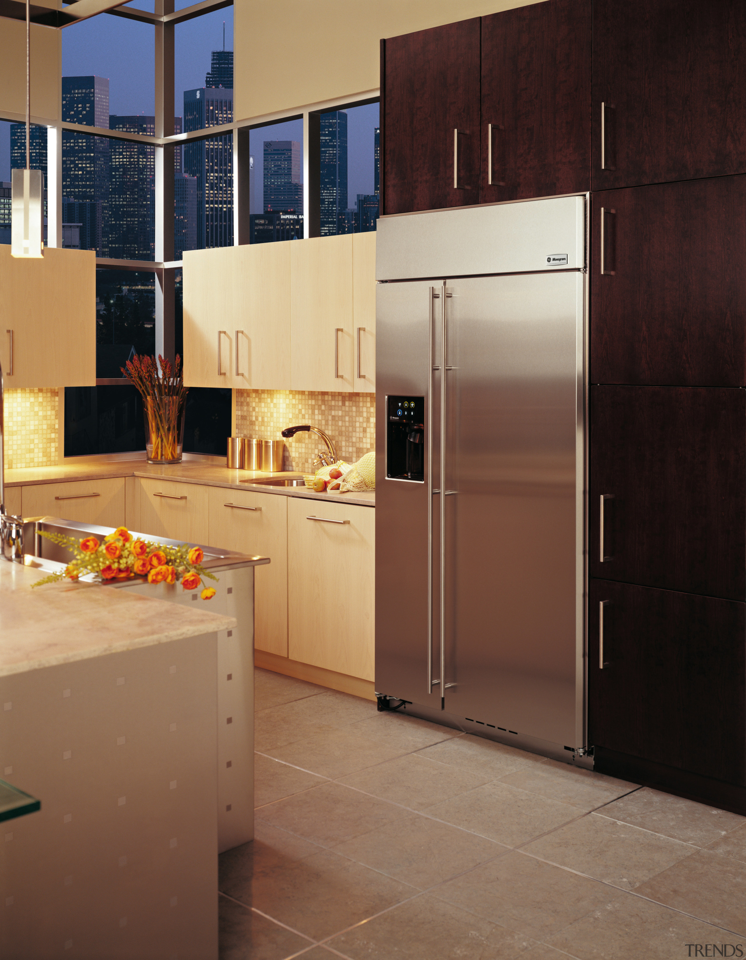 Kitchen with cream cabinetry and side by side cabinetry, countertop, floor, flooring, home appliance, interior design, kitchen, room, brown, black