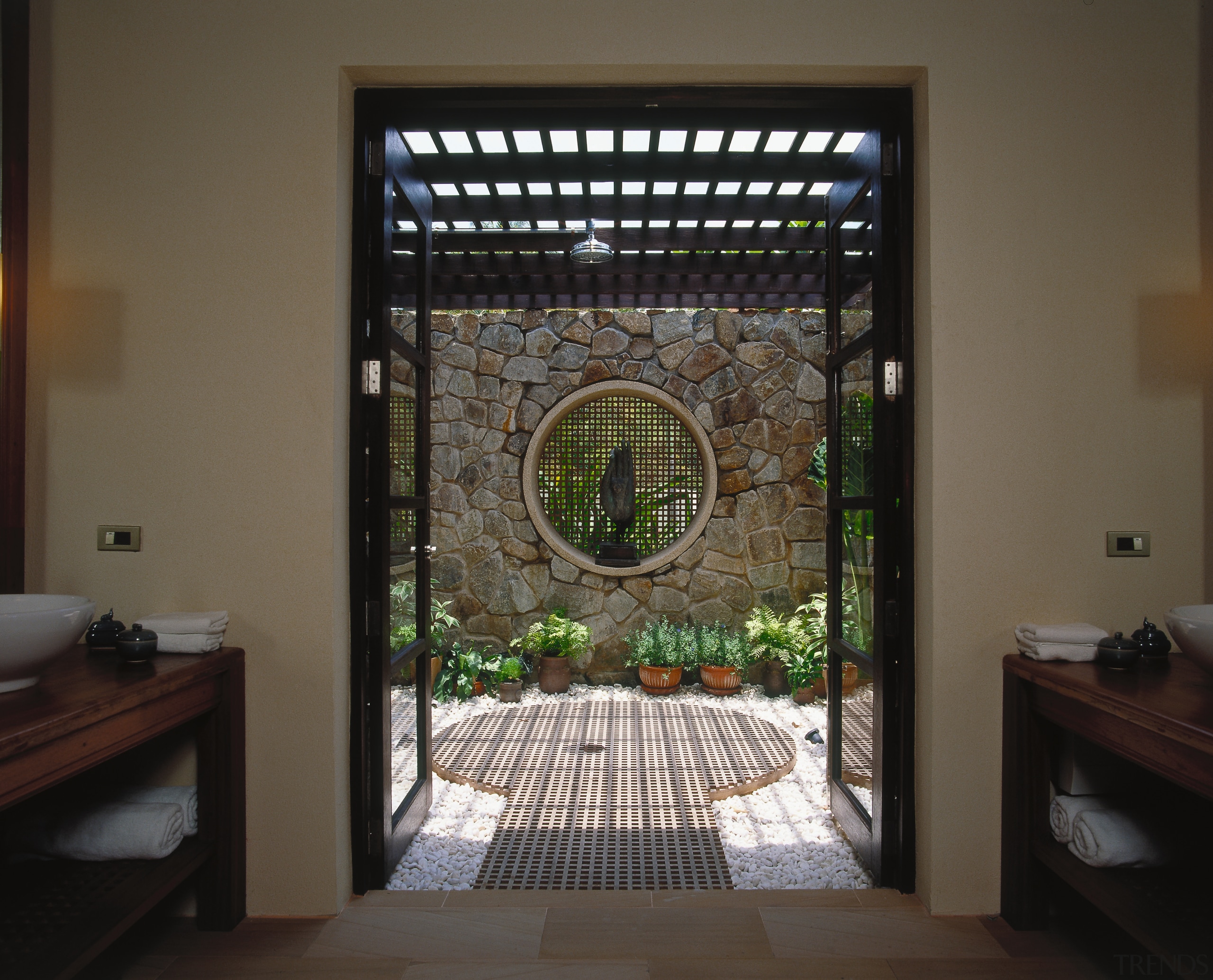 view of the outdoor shower featuring rain head glass, interior design, window, black, brown