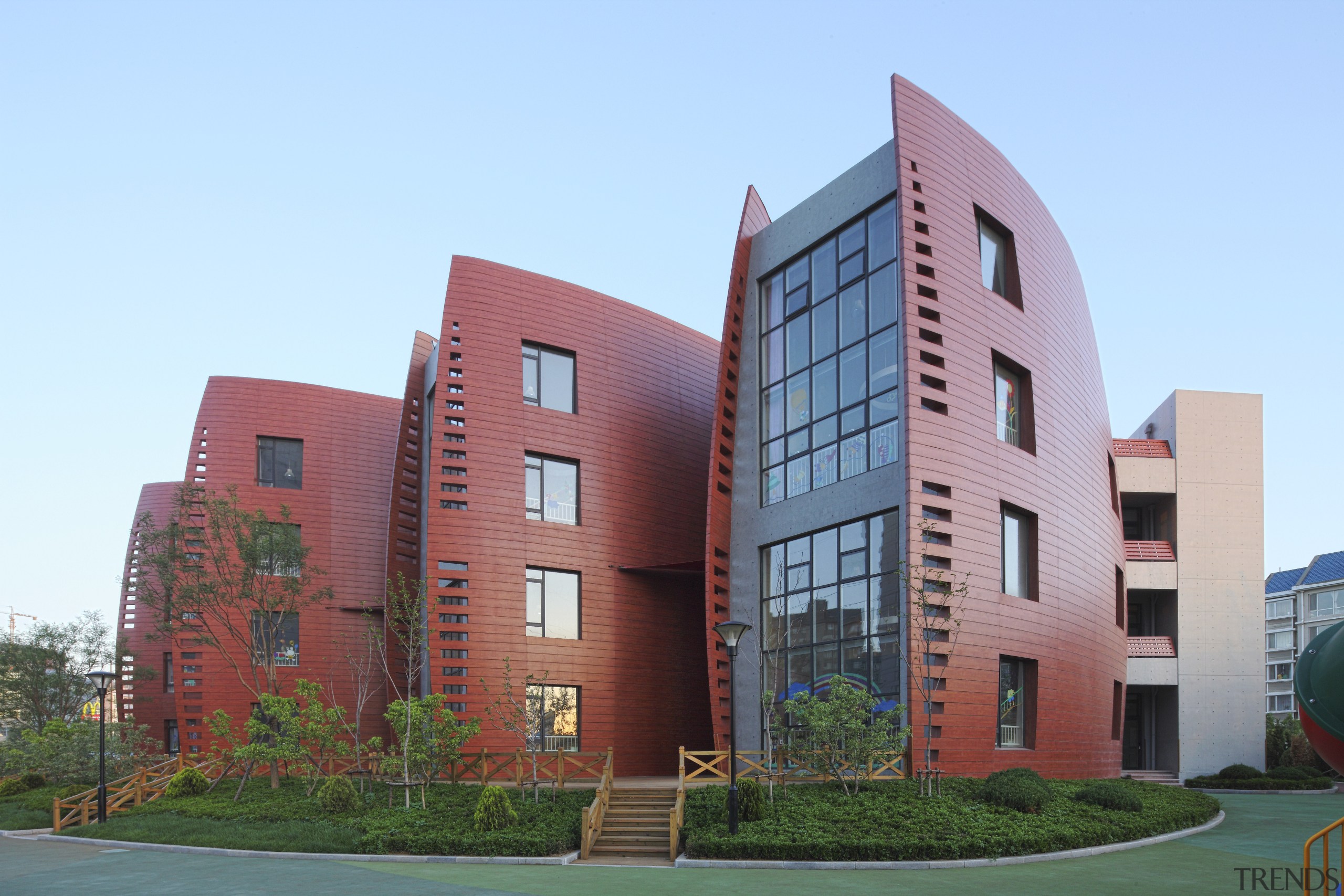 View of Dalian Preschool, with curvilinear forms and apartment, architecture, building, campus, commercial building, condominium, corporate headquarters, daytime, elevation, facade, home, house, metropolitan area, mixed use, neighbourhood, property, real estate, residential area, sky, teal