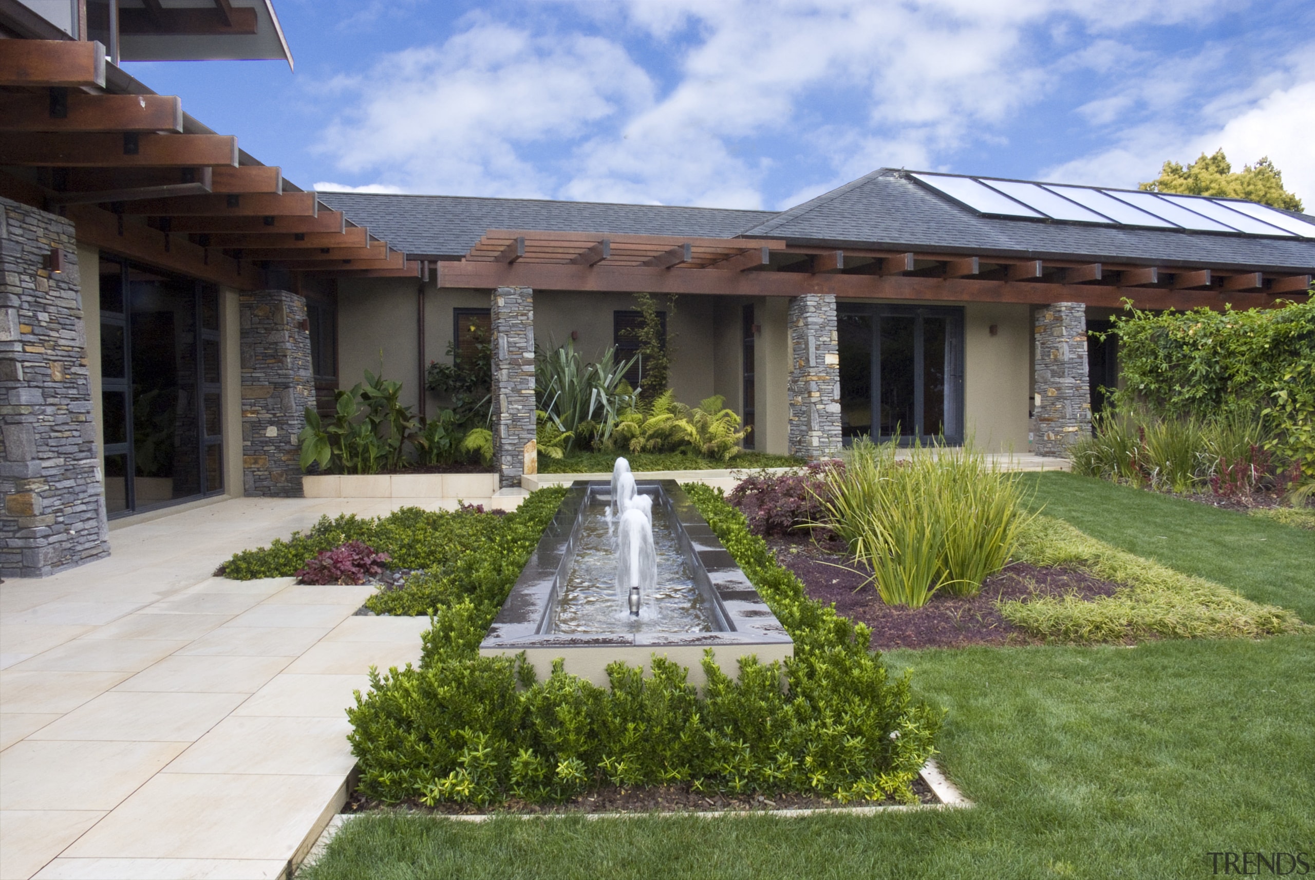 View of the formal pool with four fountains backyard, cottage, courtyard, estate, facade, garden, grass, hacienda, home, house, landscape, landscaping, mansion, outdoor structure, property, real estate, residential area, roof, villa, yard