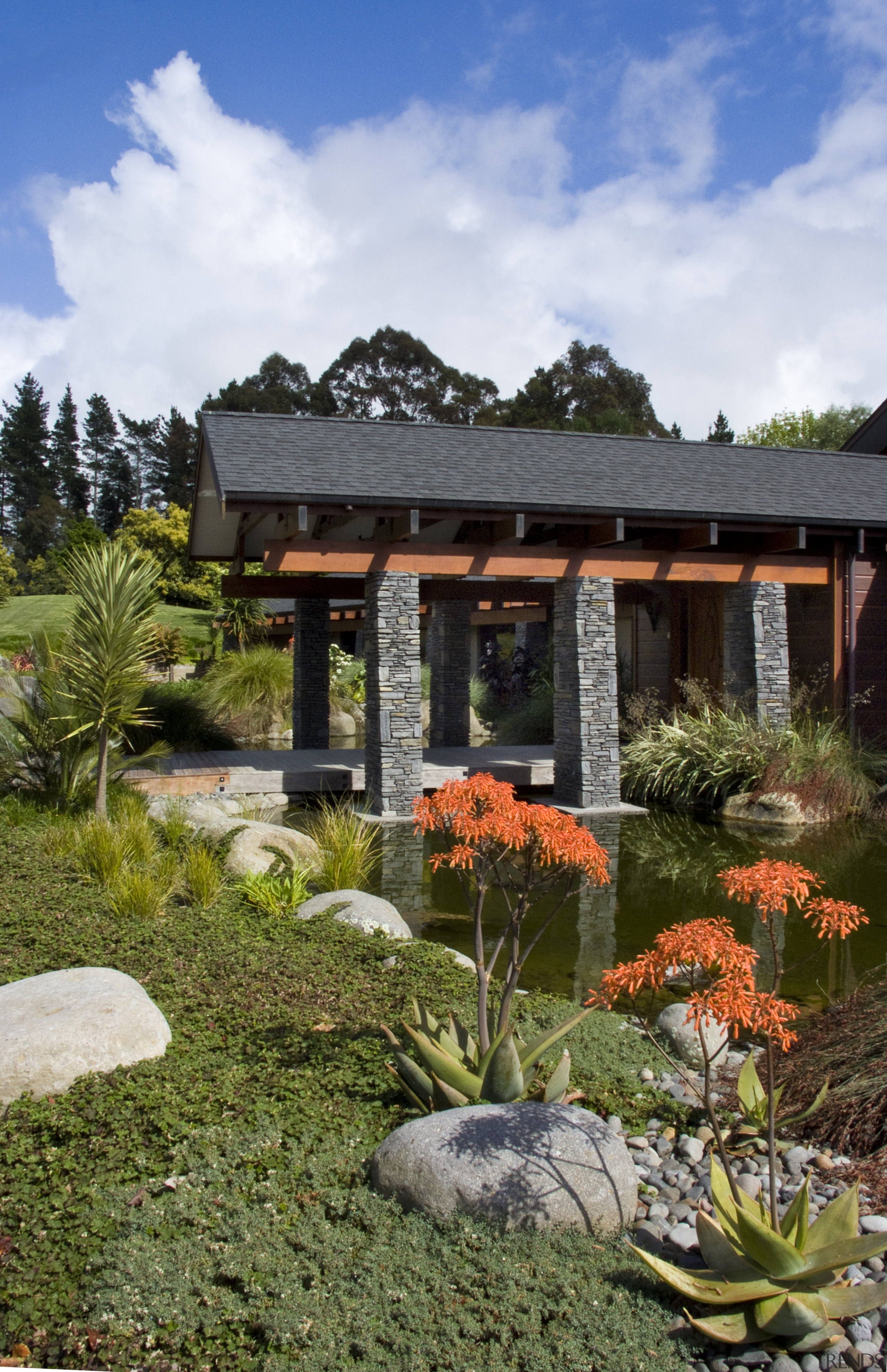 View of the entrance way which features schist estate, garden, grass, landscape, landscaping, plant, real estate, tree, brown