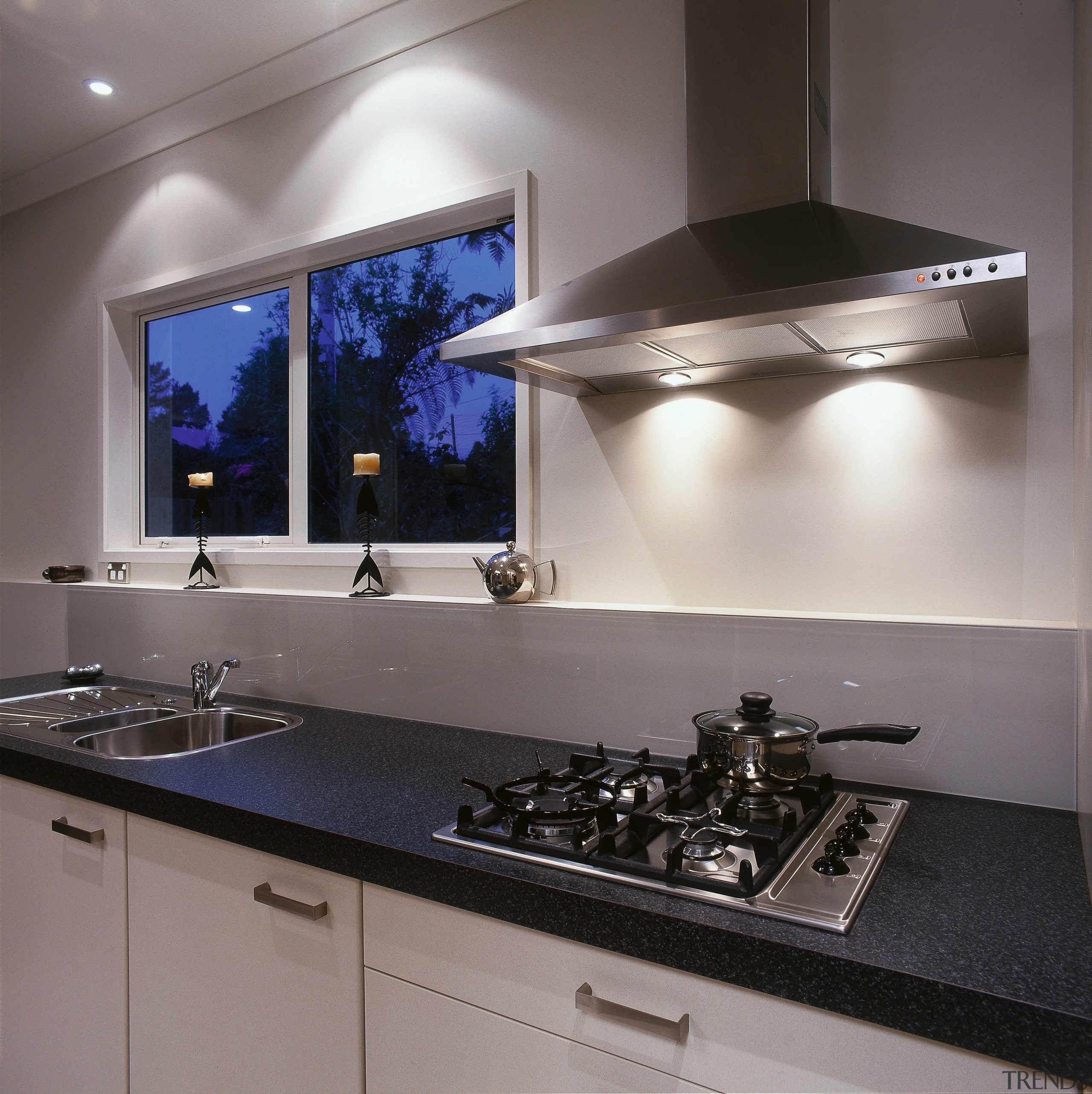 A vie wof a kitchen with various stainless countertop, interior design, kitchen, kitchen stove, sink, under cabinet lighting, gray, black